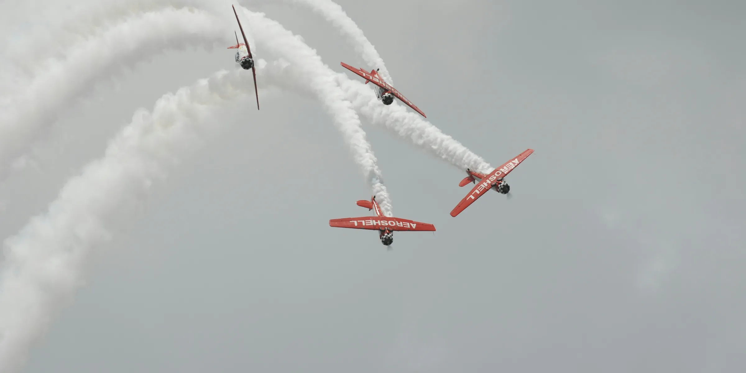 four red biplanes air exhibition