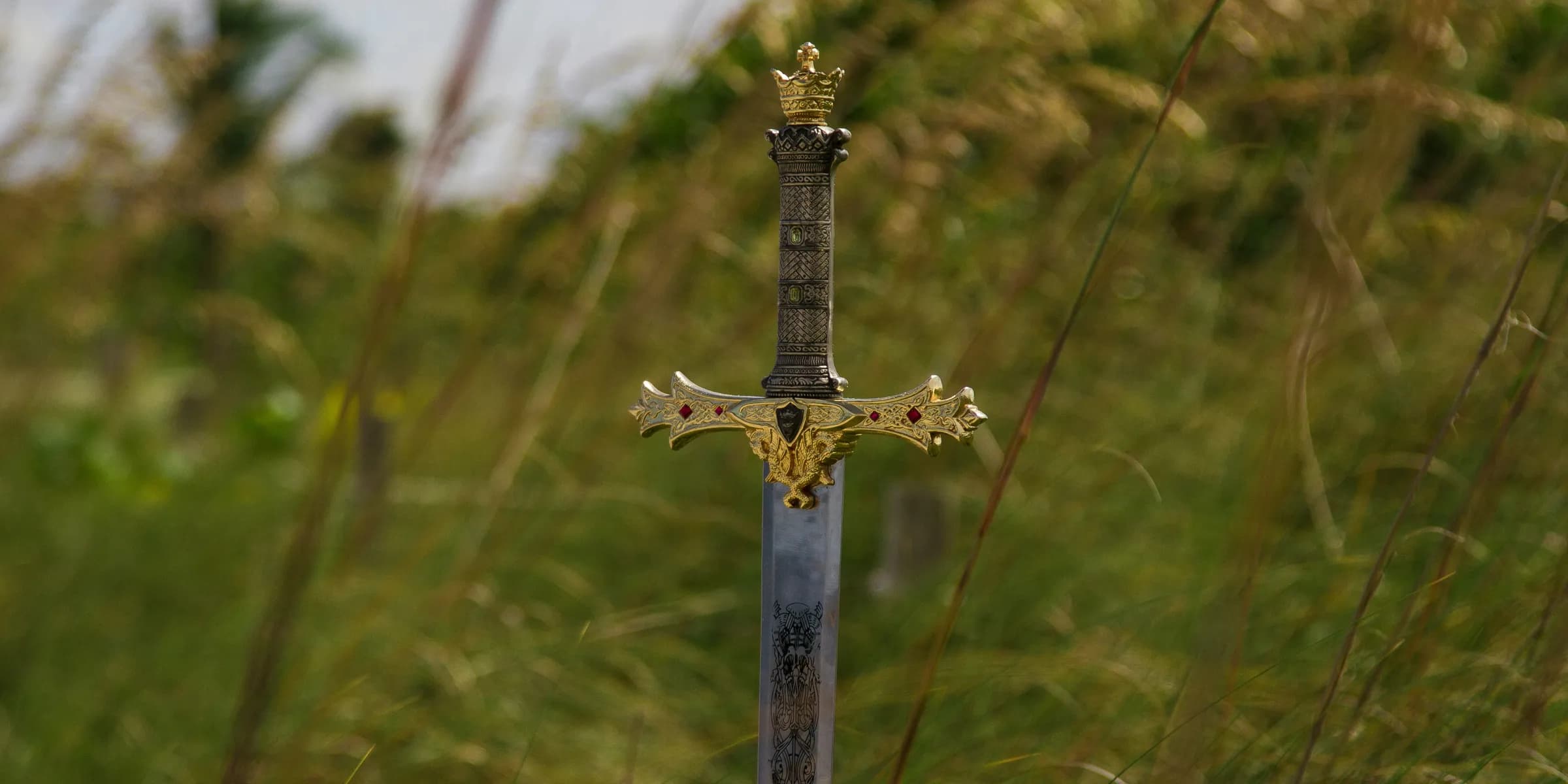 gray steel sword on ground during daytime