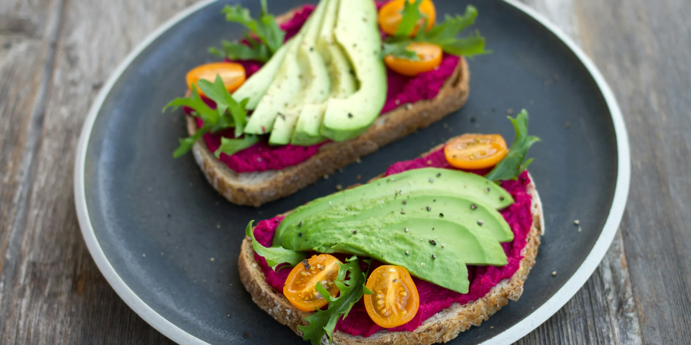 two sliced breads with avocado on top
