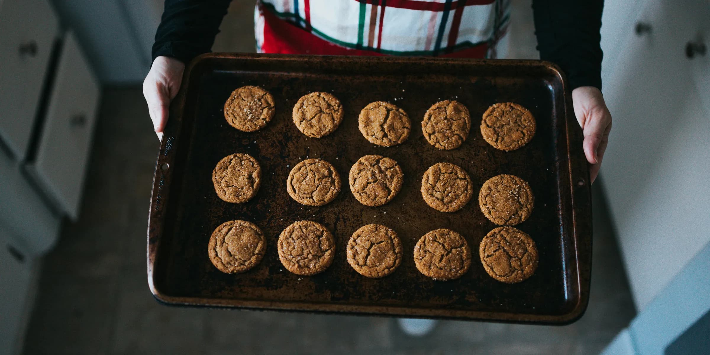 person holding tray of cookies