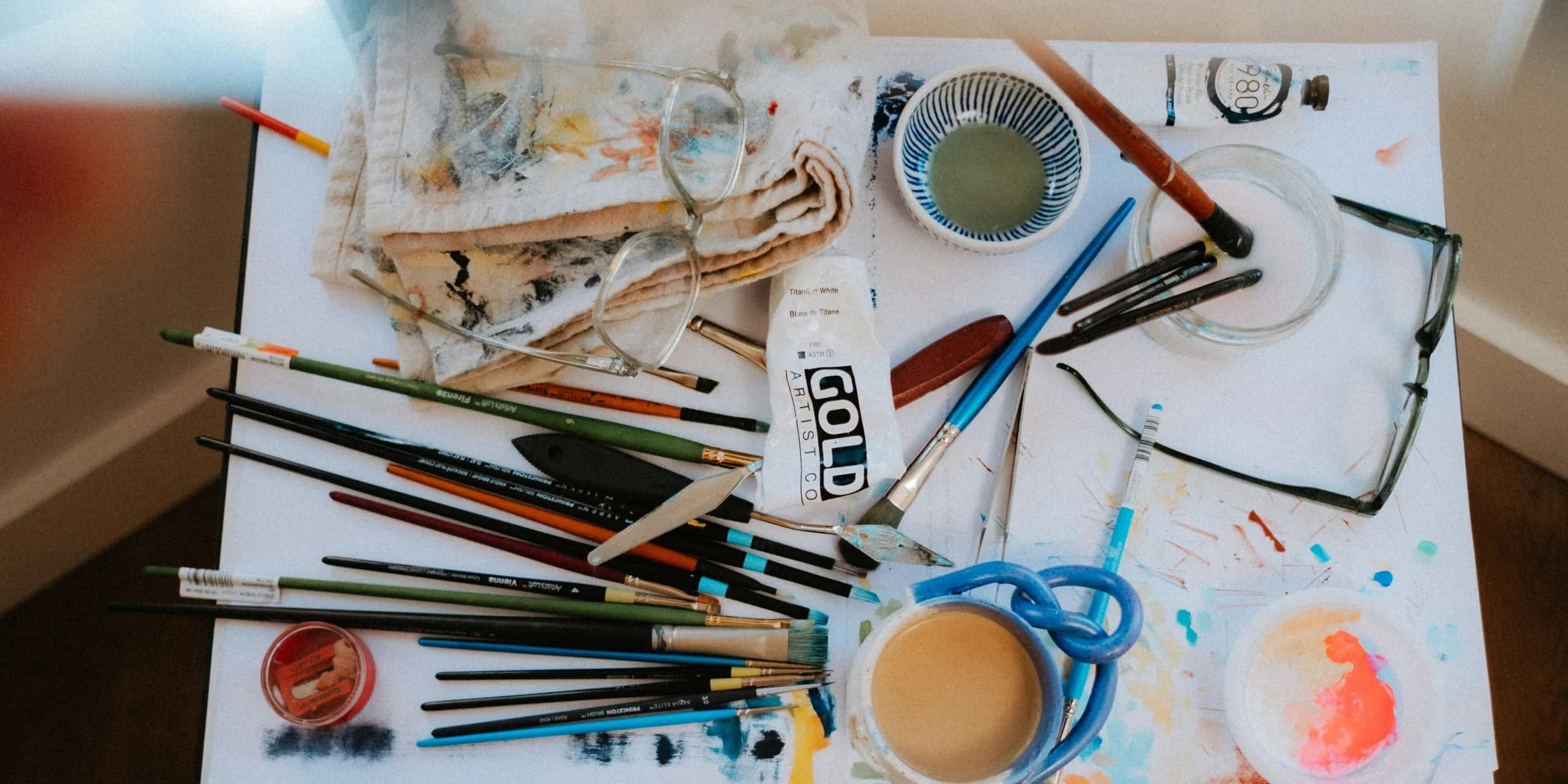 a table topped with lots of art supplies