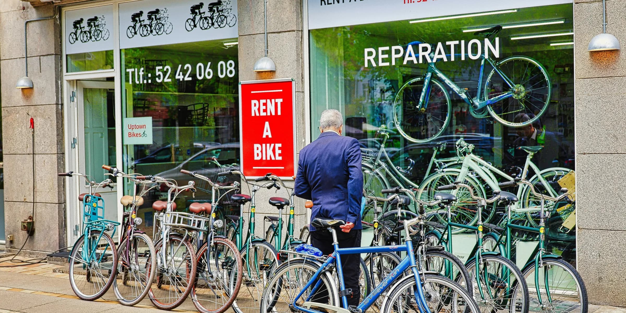 Man looking at bicycles outside a rental shop