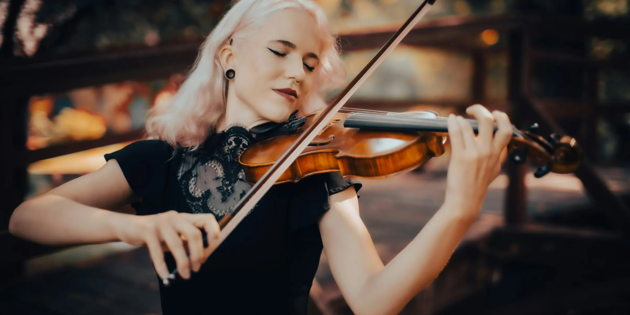 A woman playing a violin in a park