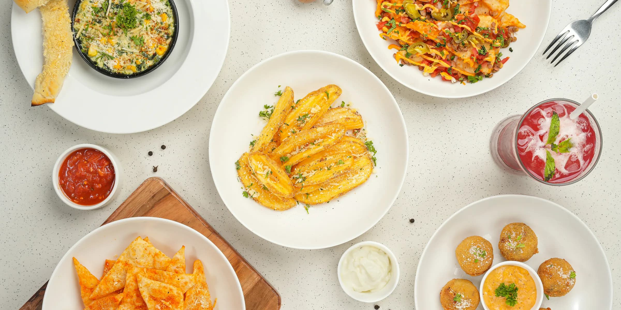 A table topped with plates and bowls of food