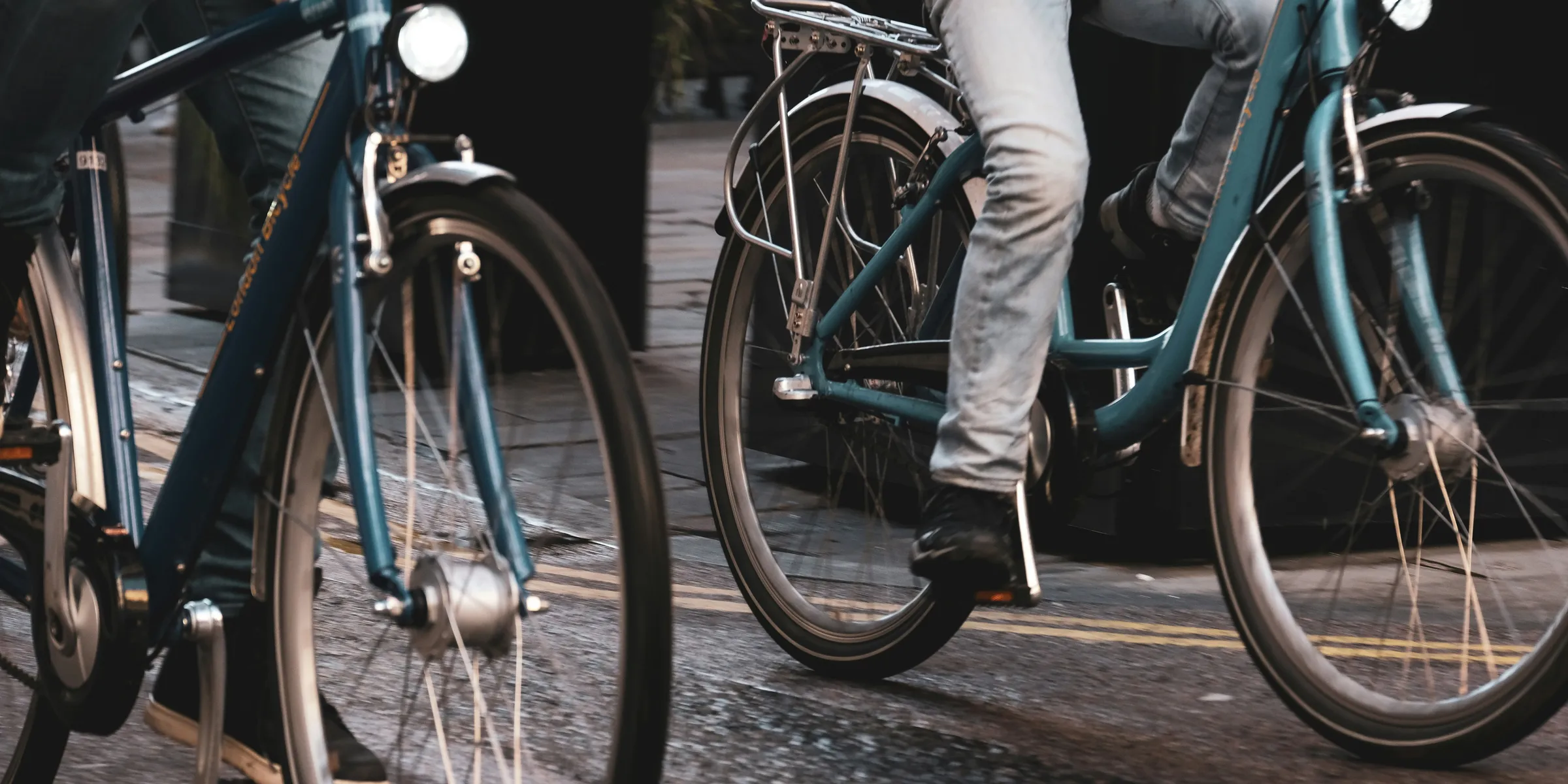 two people riding bicycles