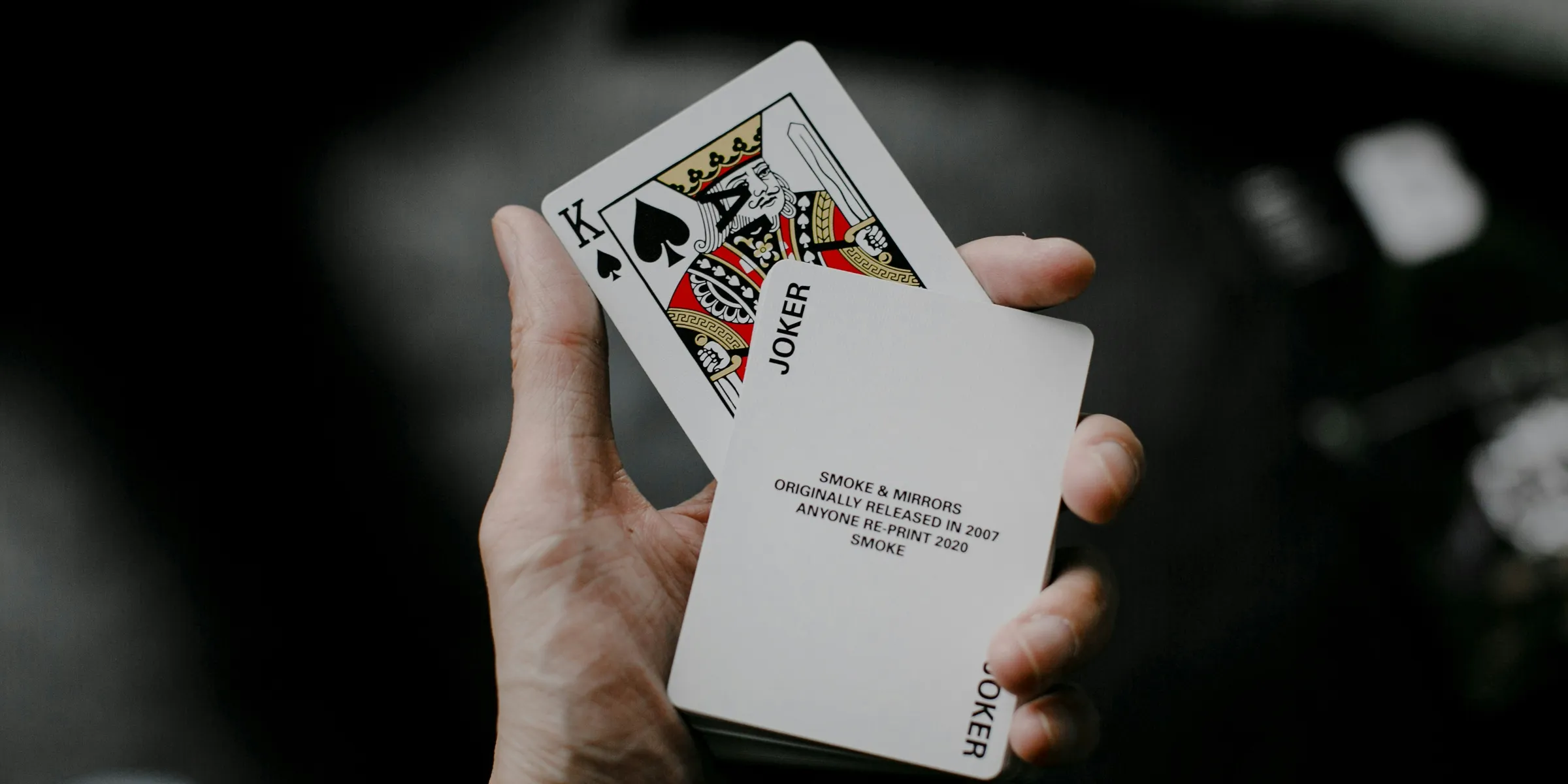 person holding joker playing card