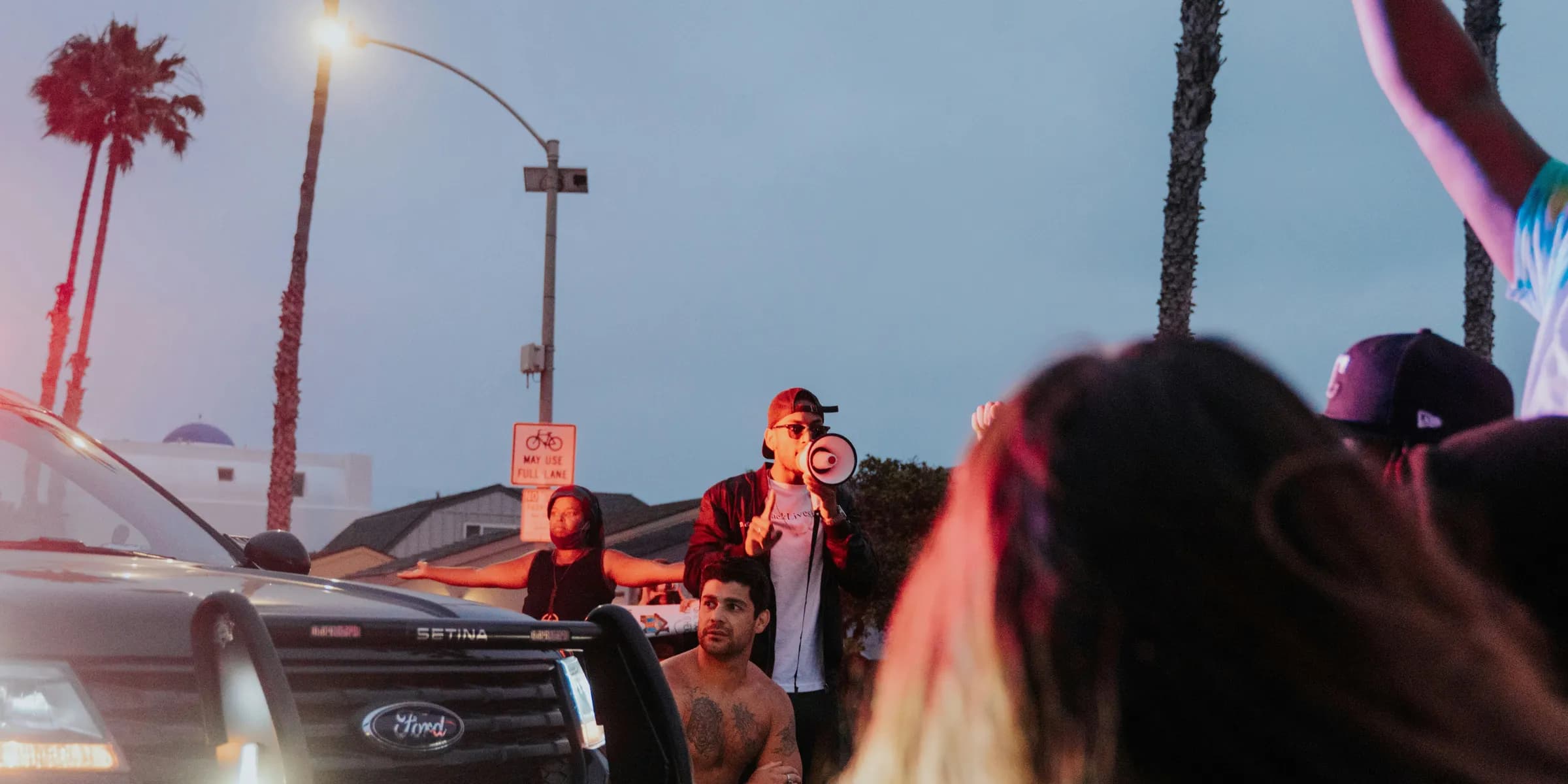 people standing near black car during daytime