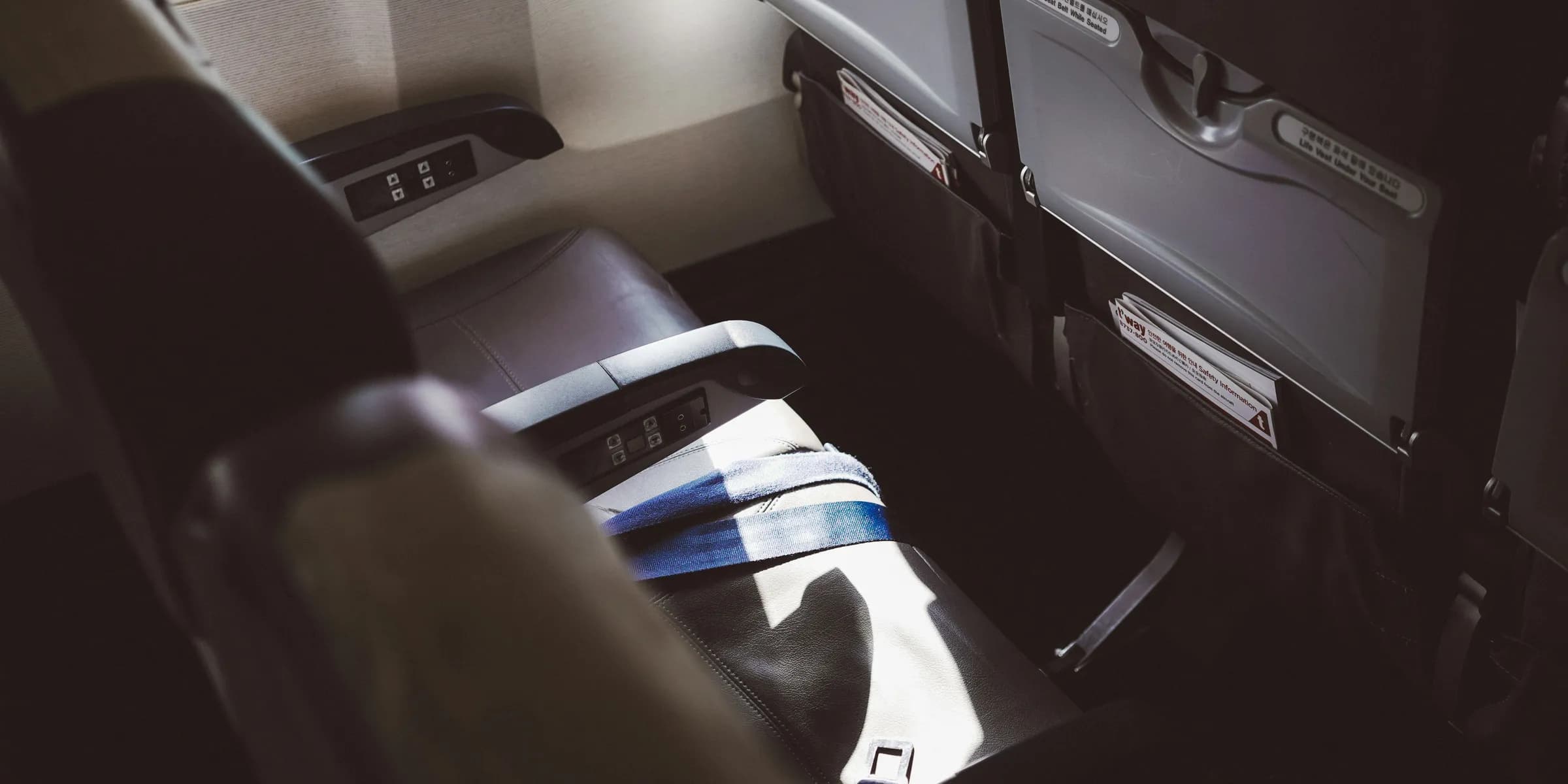 person in blue white and black shorts sitting on car seat