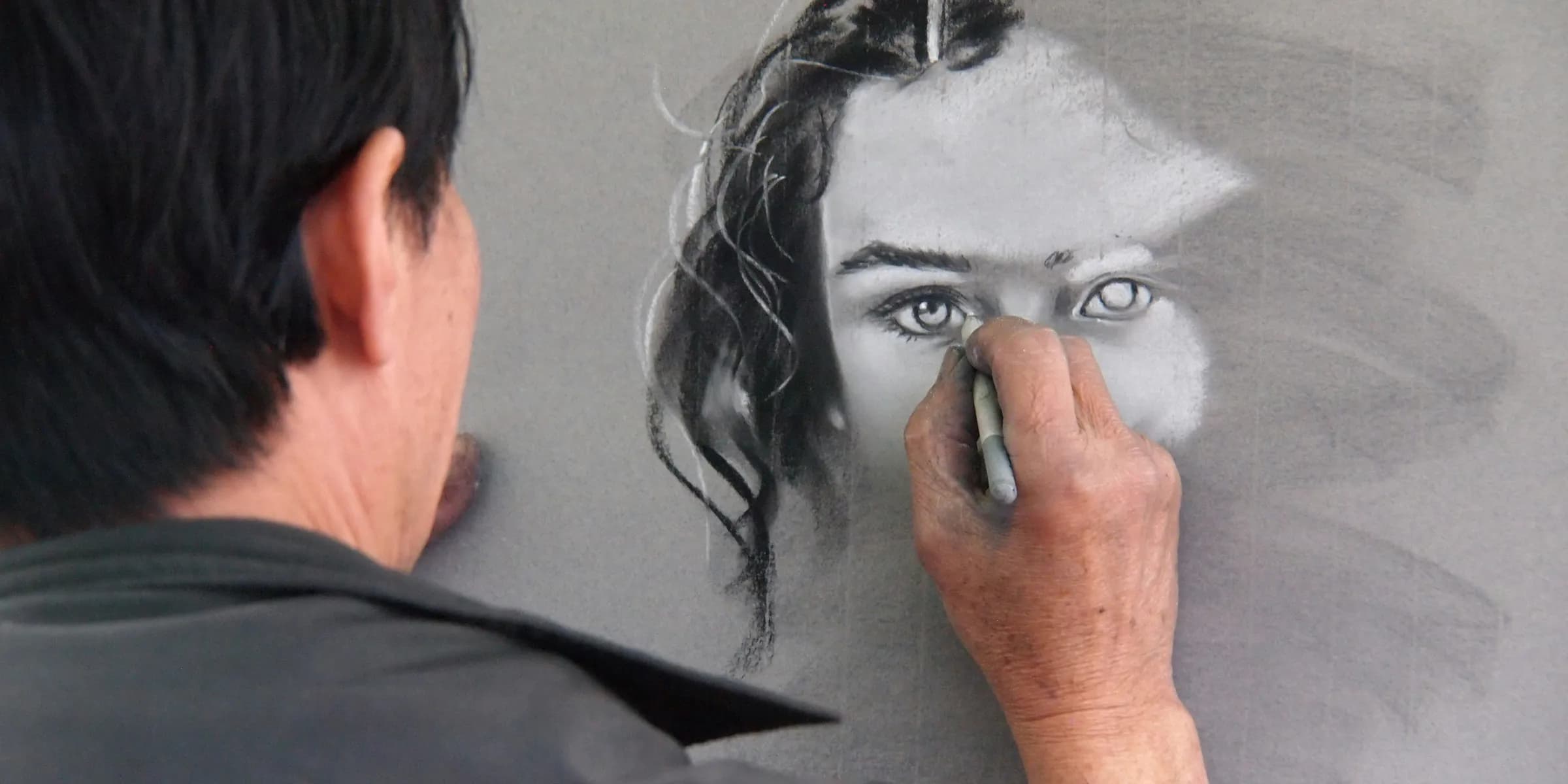 man sketching portrait of woman