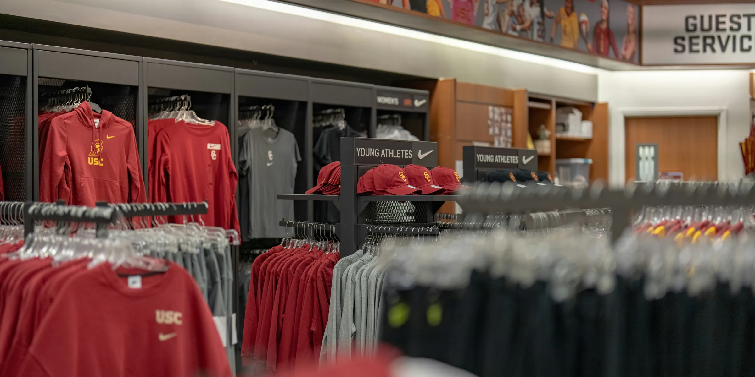 a store filled with lots of red and black shirts