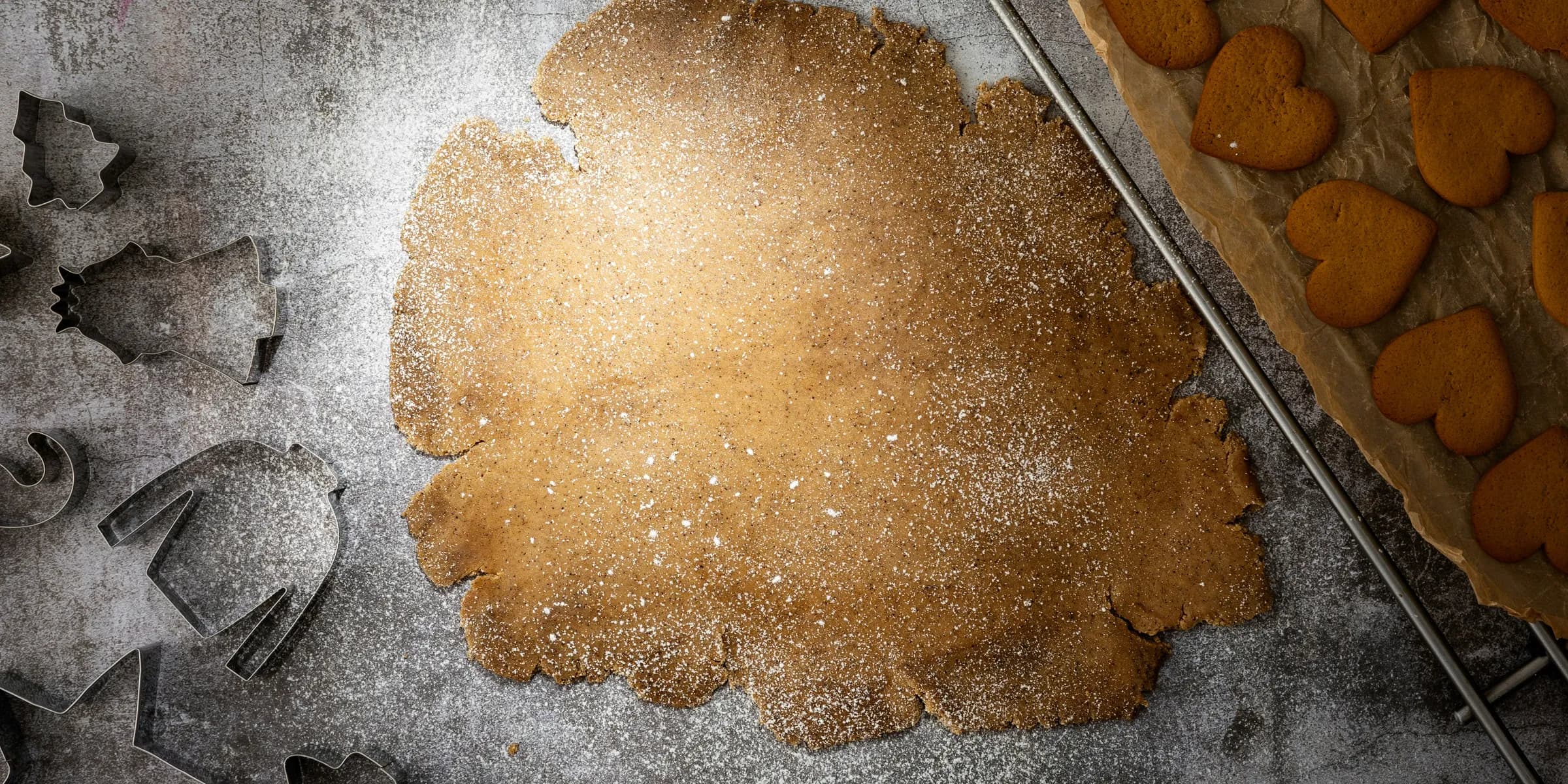 a cookie dough and cookie cutters on a table