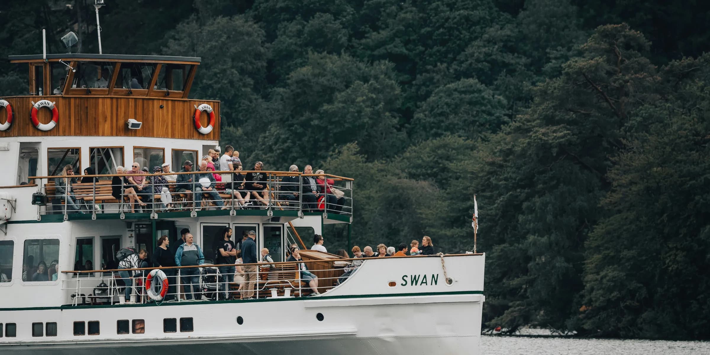 a boat full of people sailing on the water