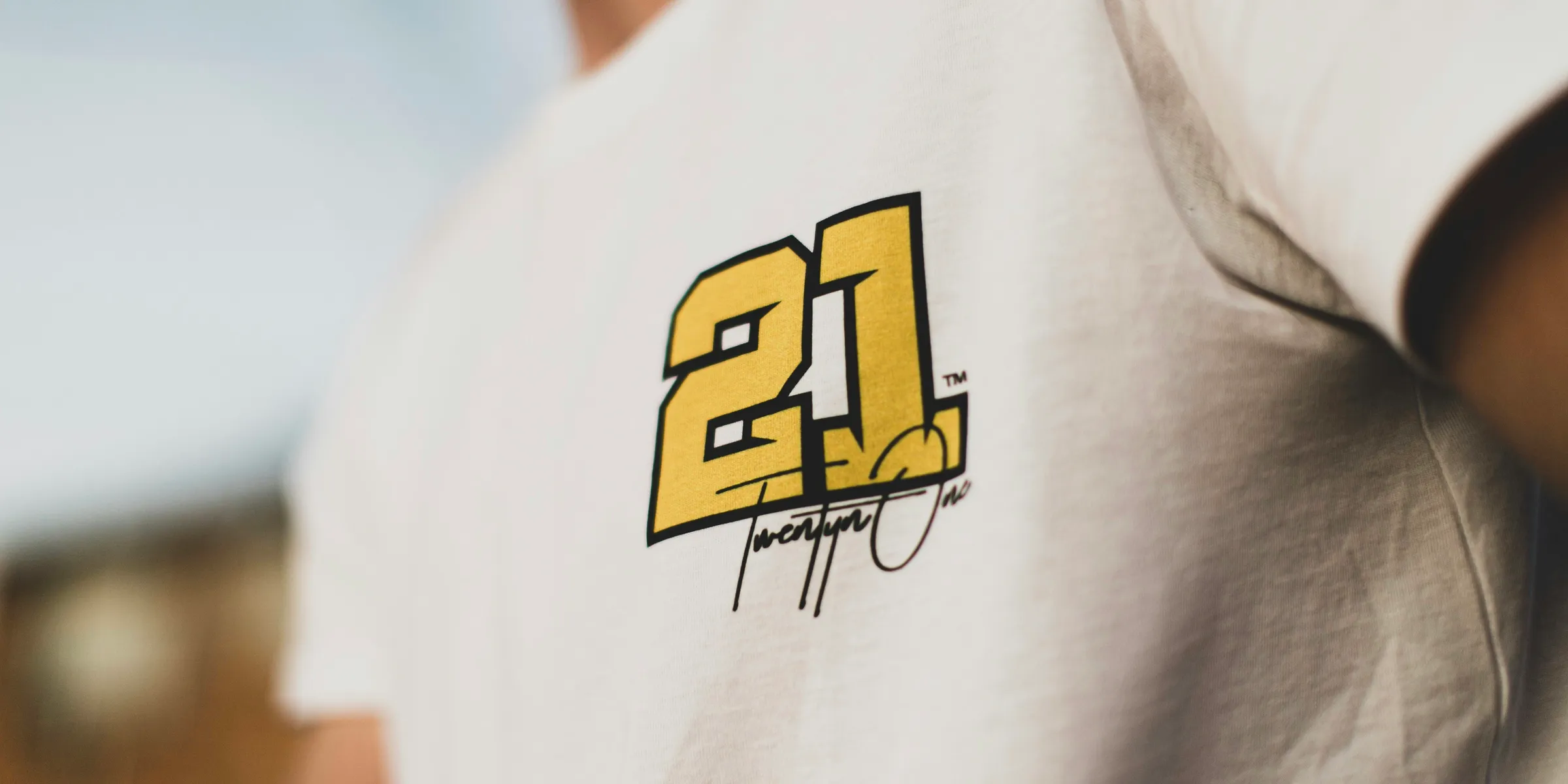 man in white shirt with 21 print