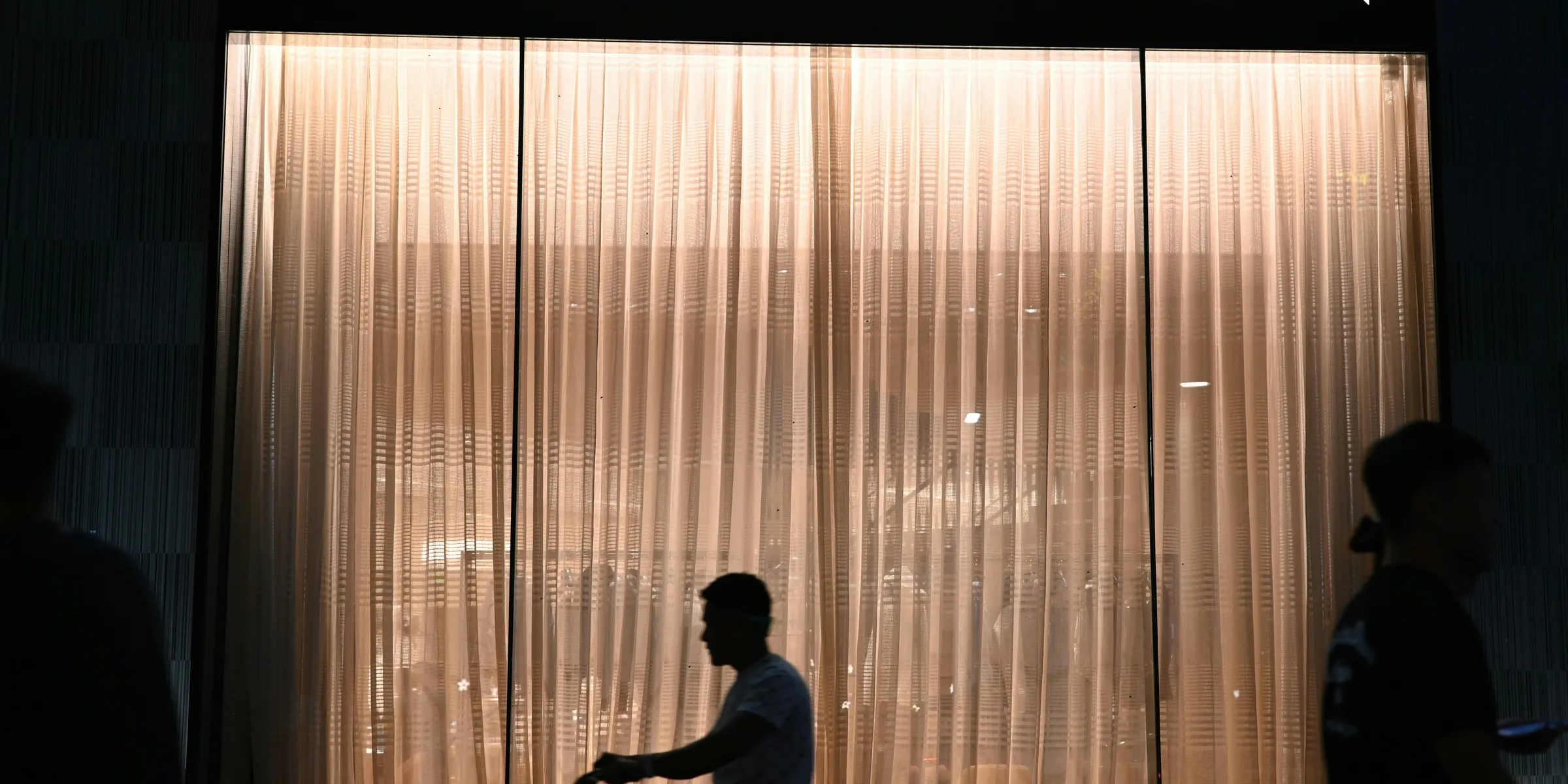 Louis vuitton store at night with people walking