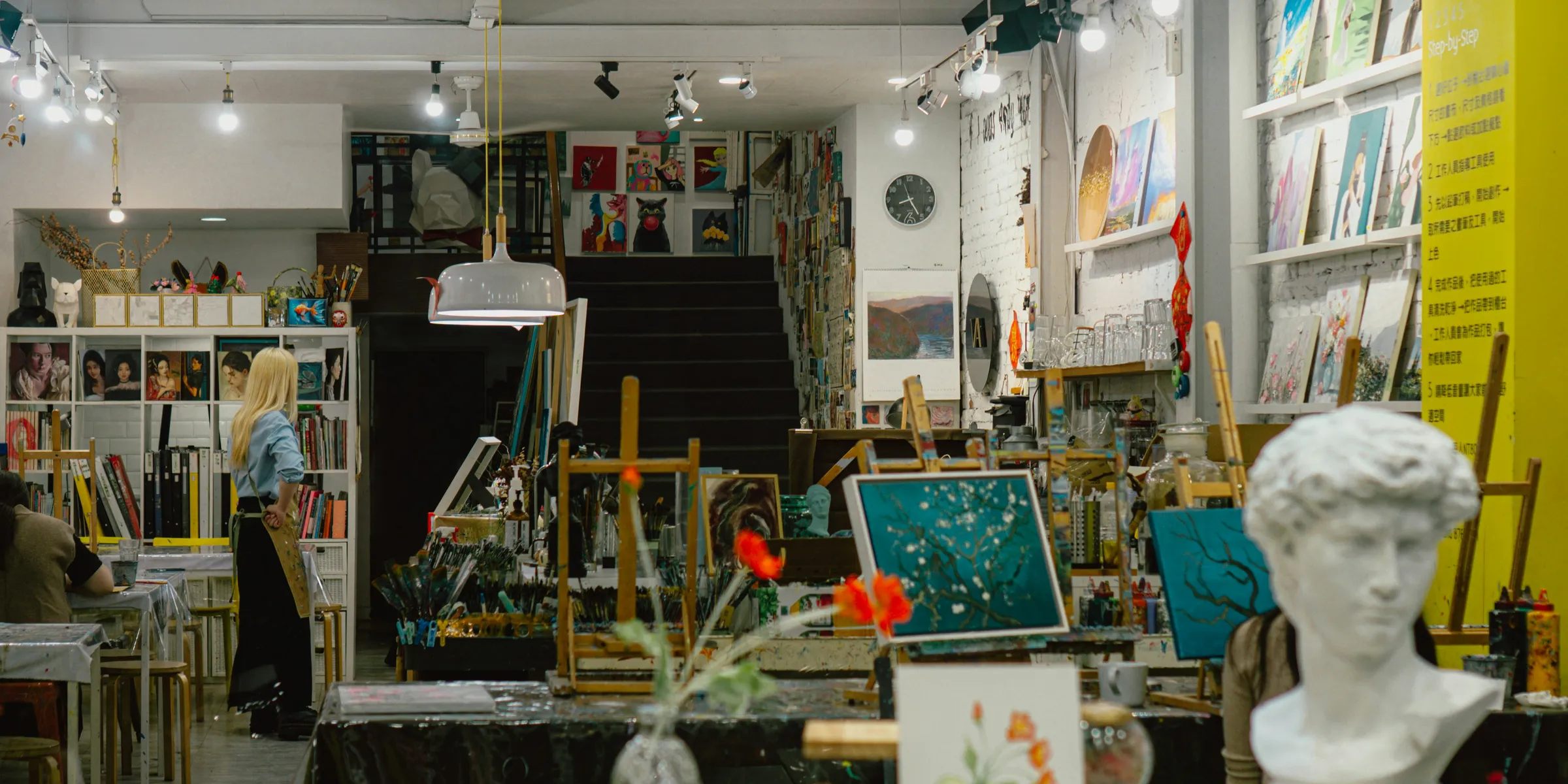 Art studio interior filled with easels and artwork.