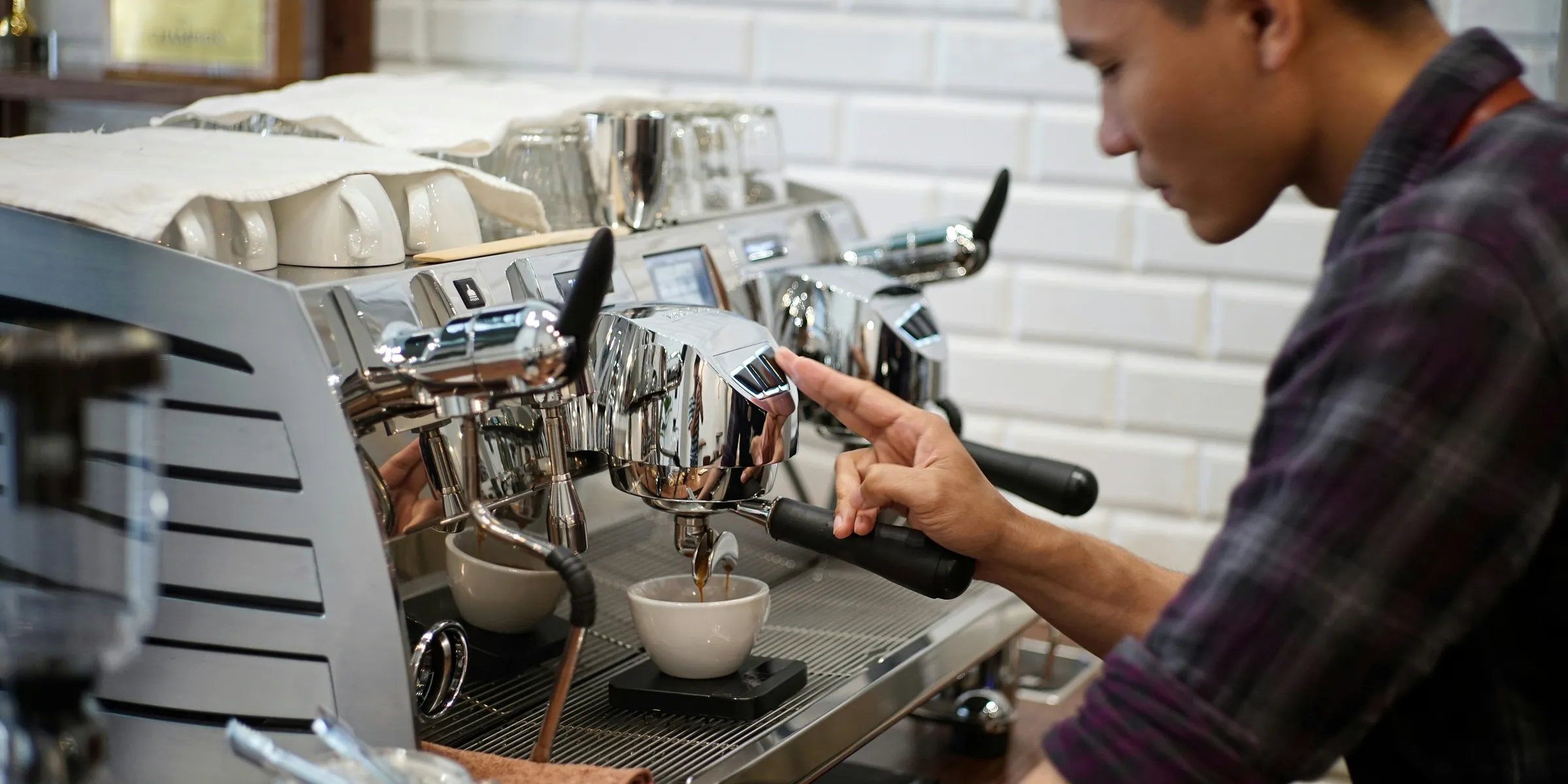 a man is making a cup of coffee