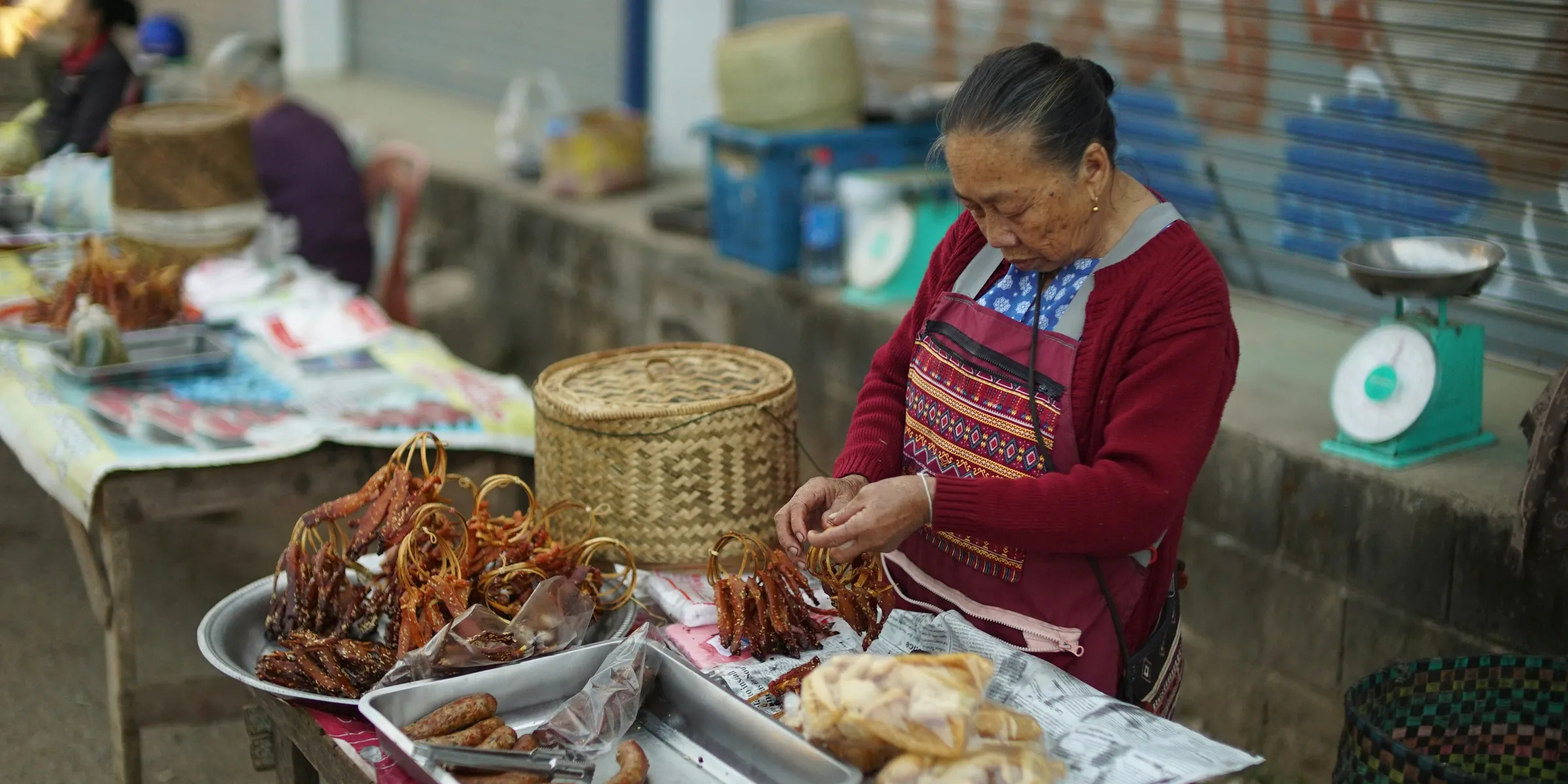 old woman sitting and selling food in the market
