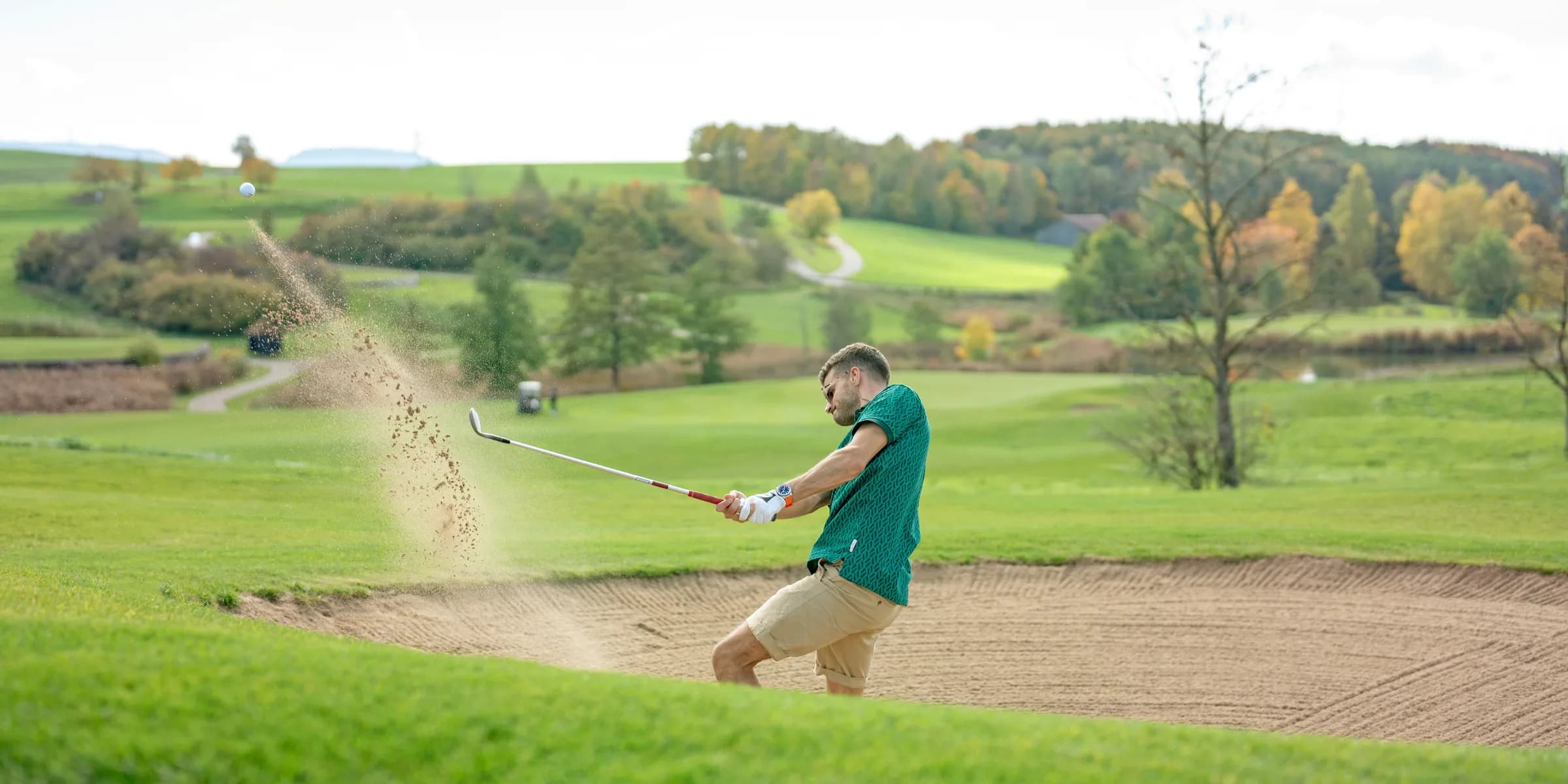 a man hitting a golf ball with a golf club