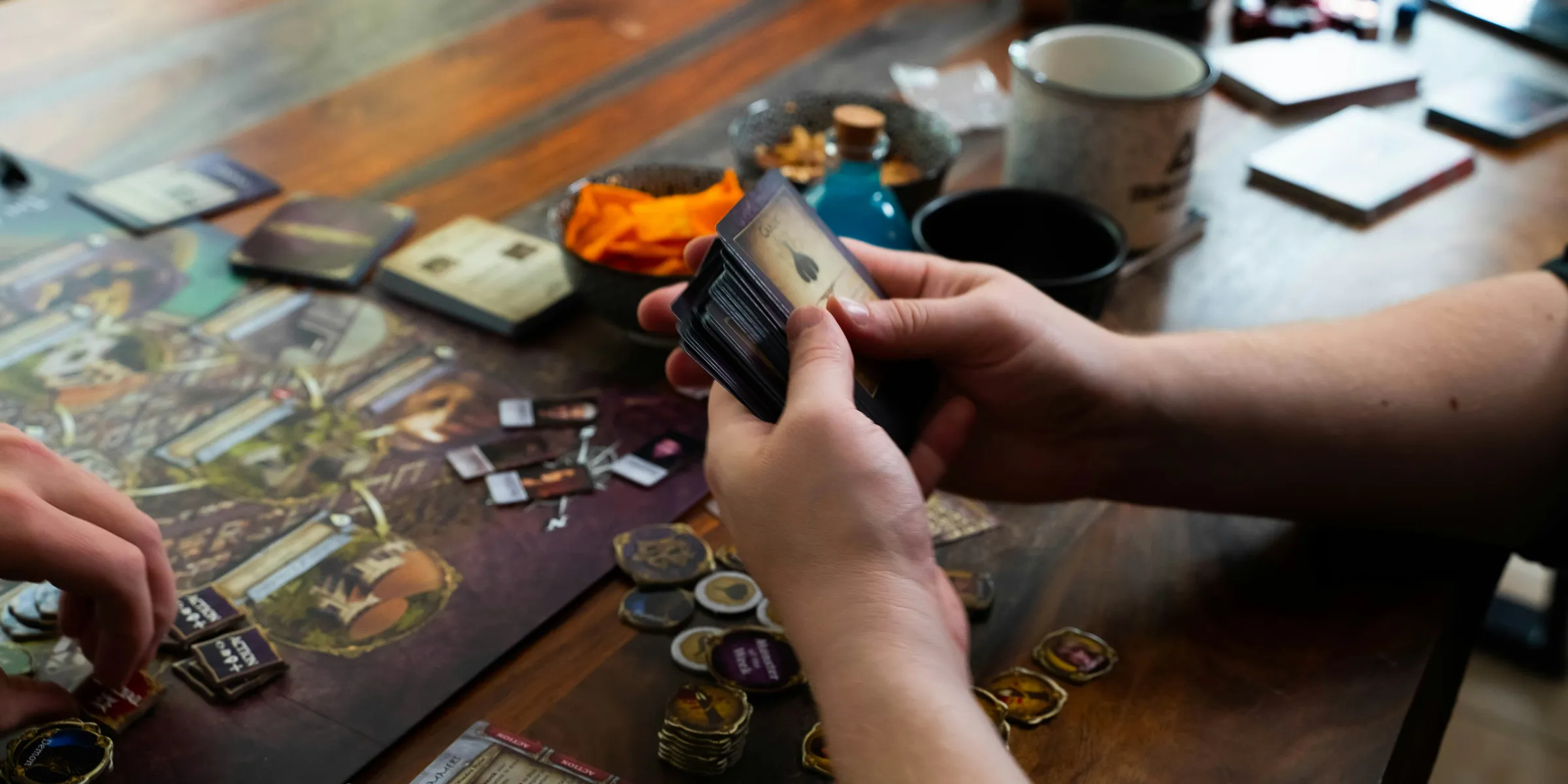 two people playing a board game on a table