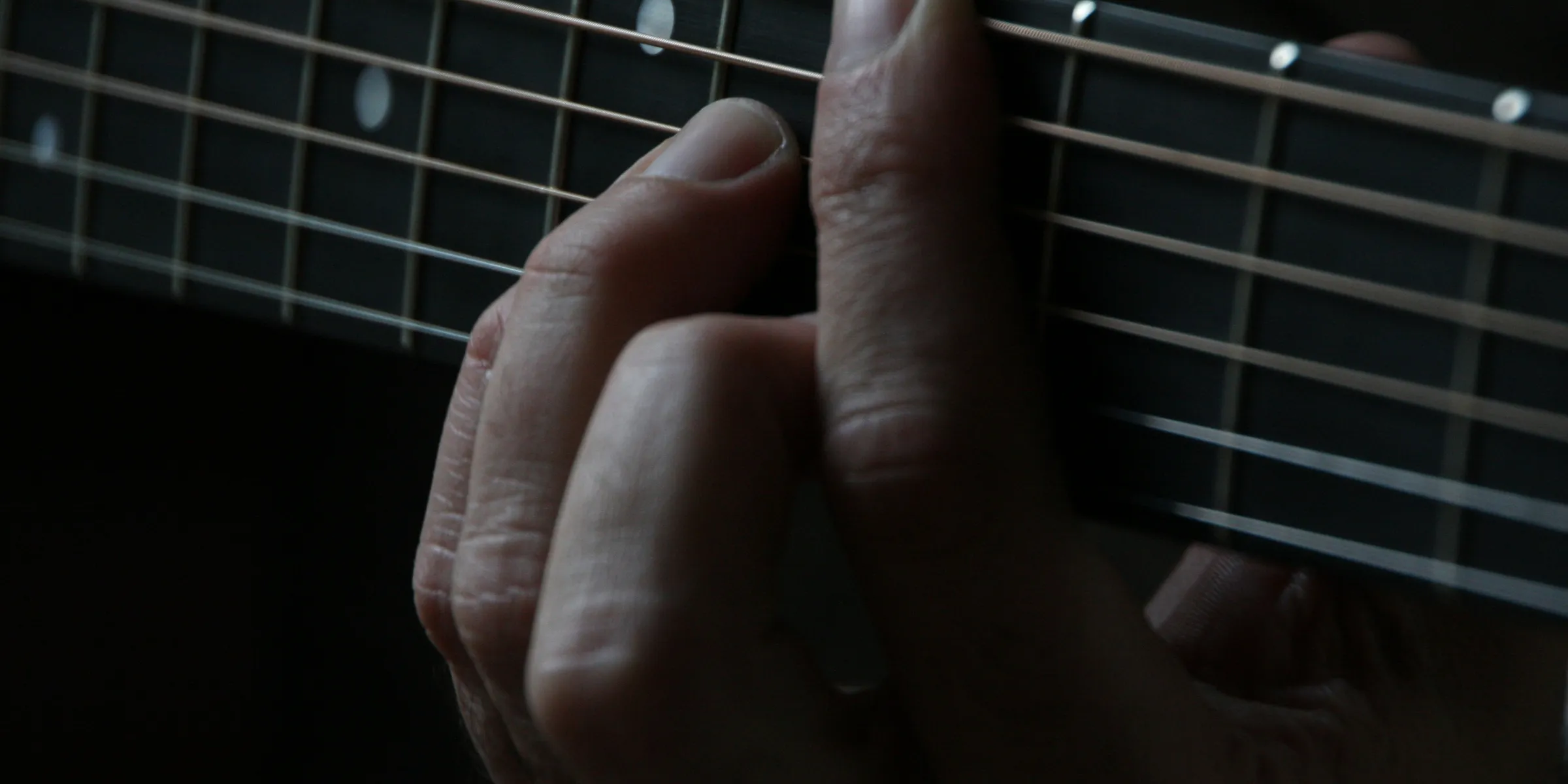 person using guitar