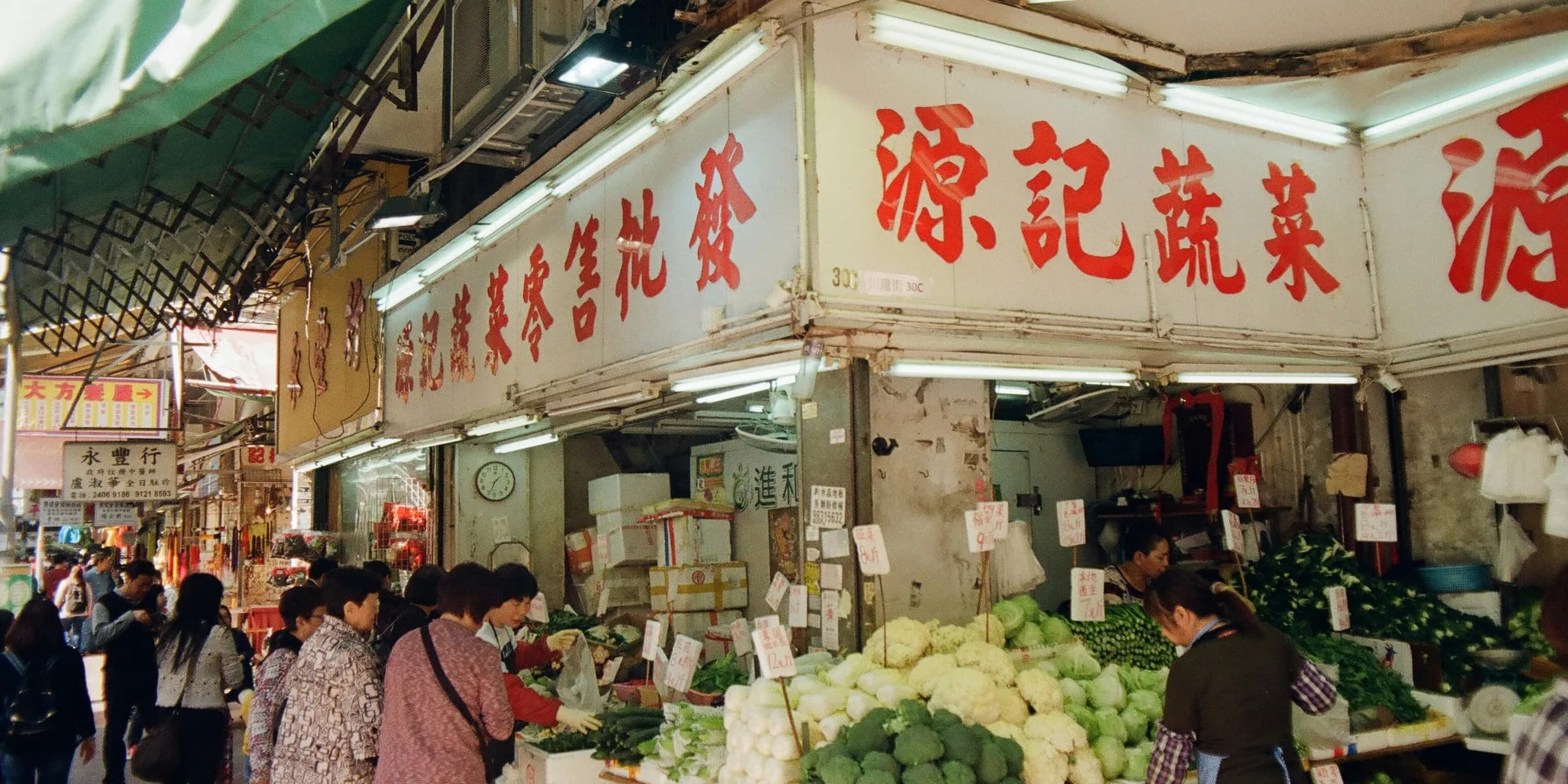 people at the vegetable station inside market