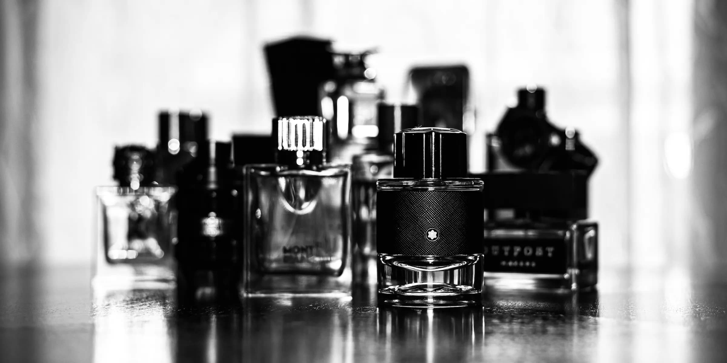 black and white image of fragrance bottles