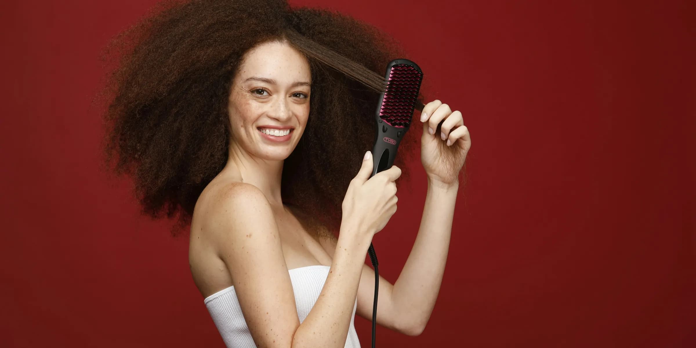 a woman holding a hair brush in her hand