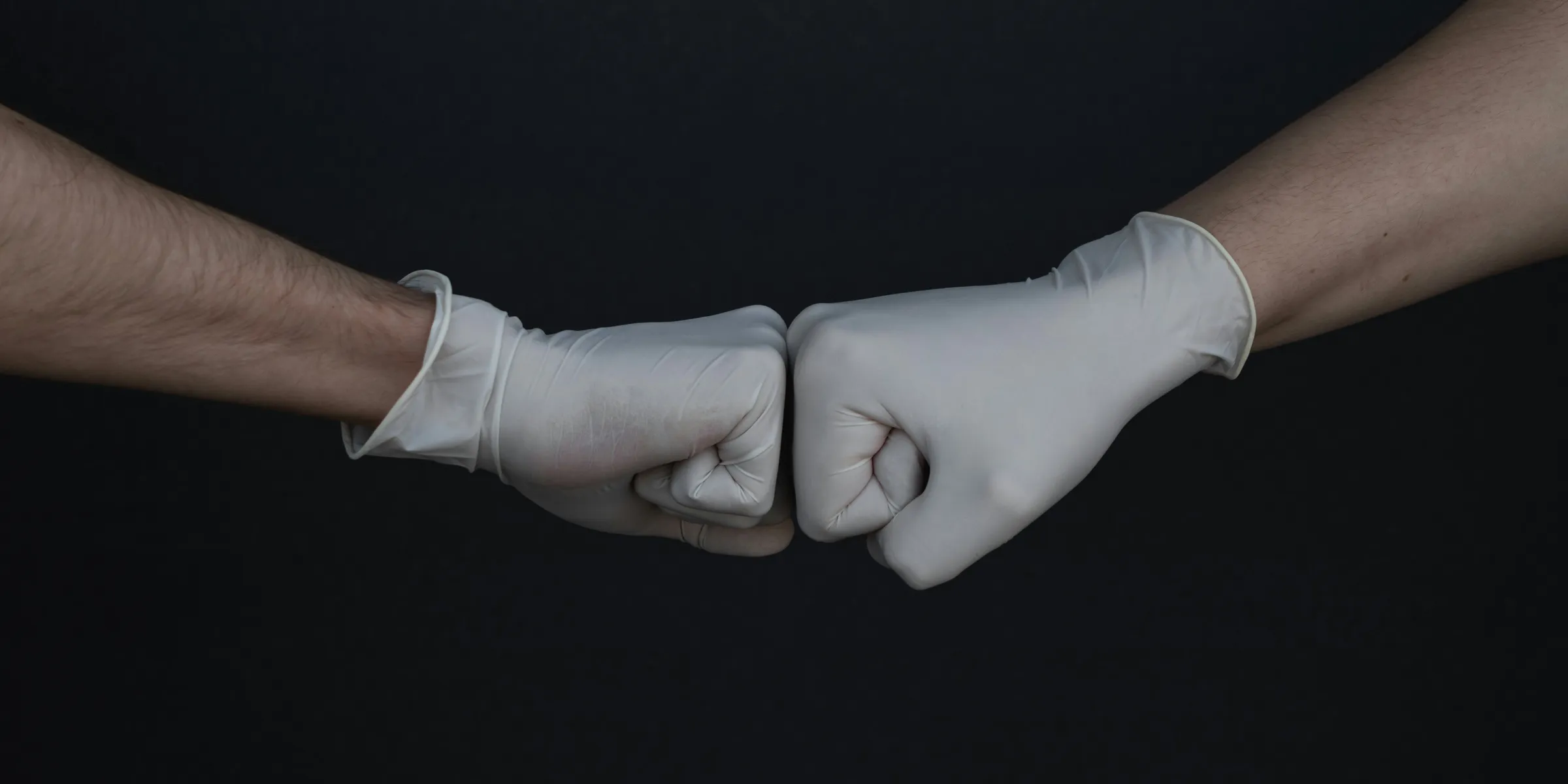 person wearing white long sleeve shirt and white gloves