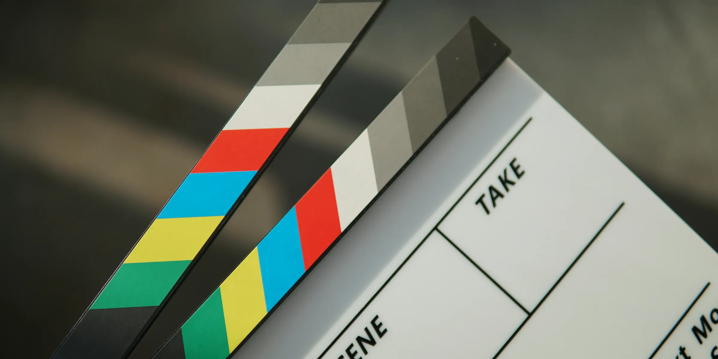 A person holding a clapstick in their hand