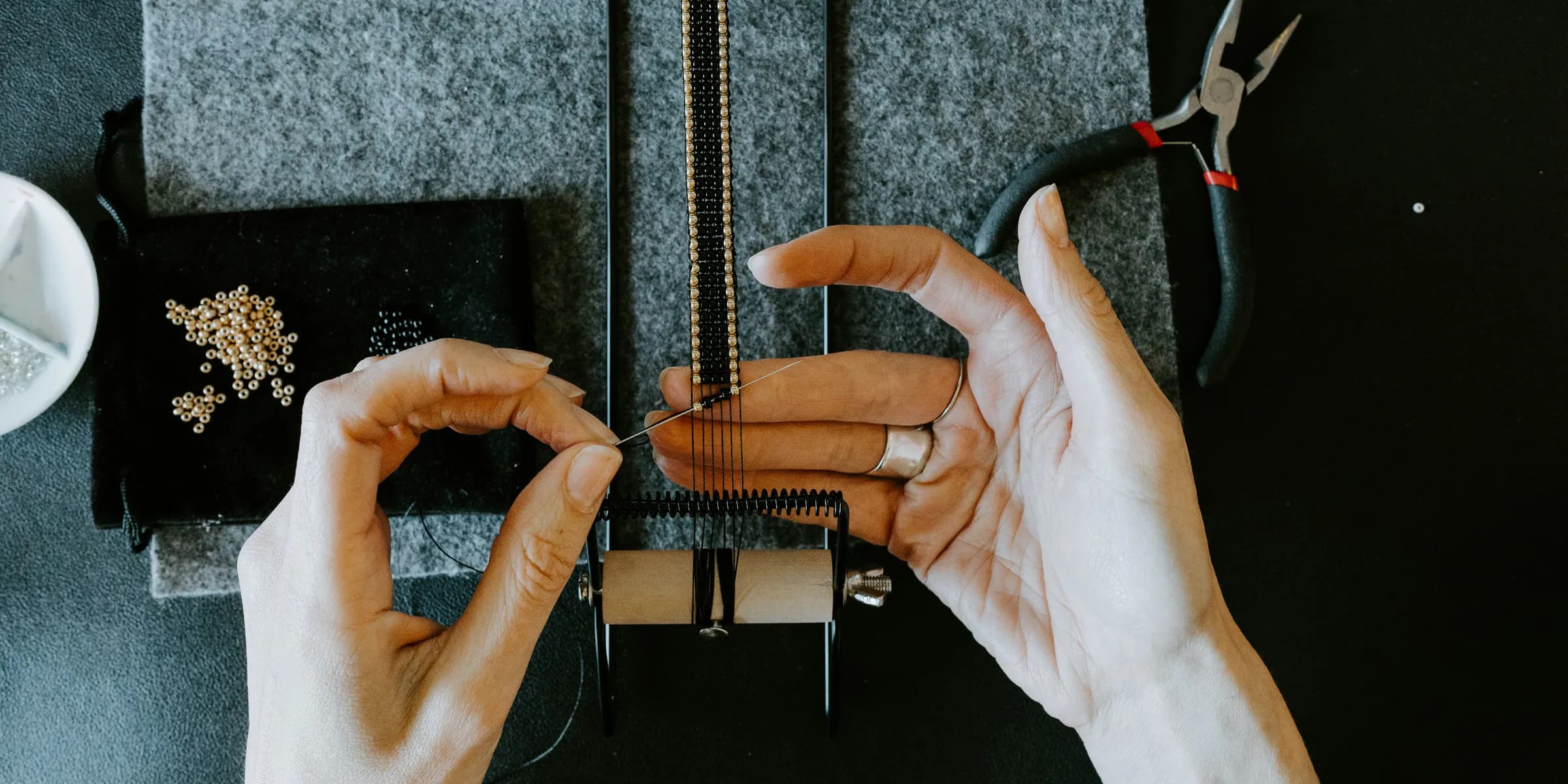a woman is working on a piece of jewelry