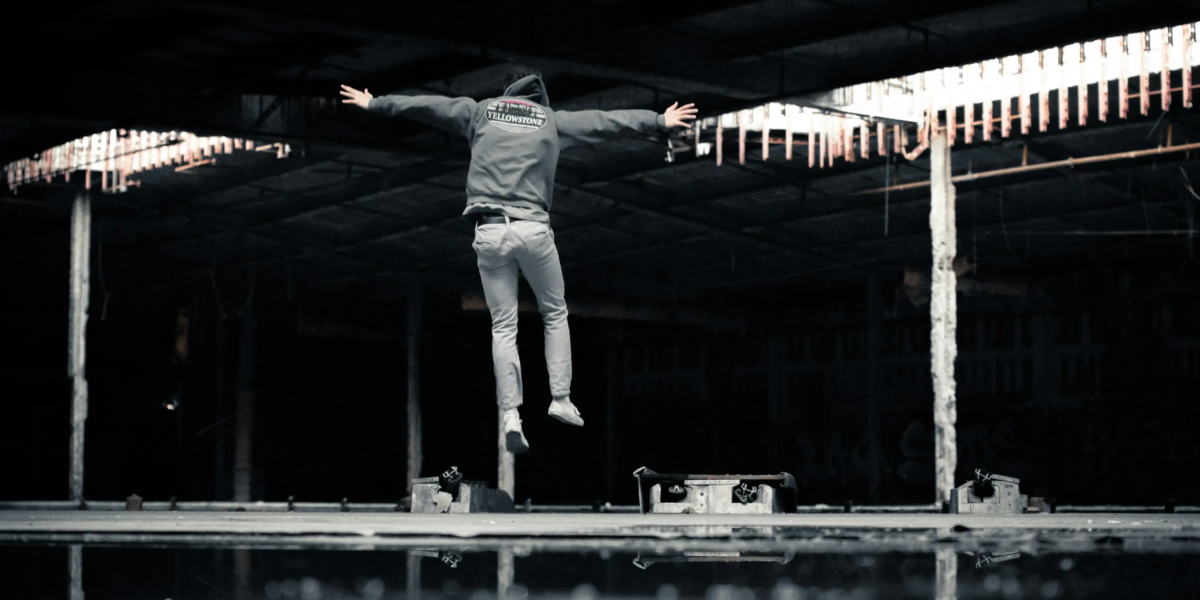 man jumping inside building