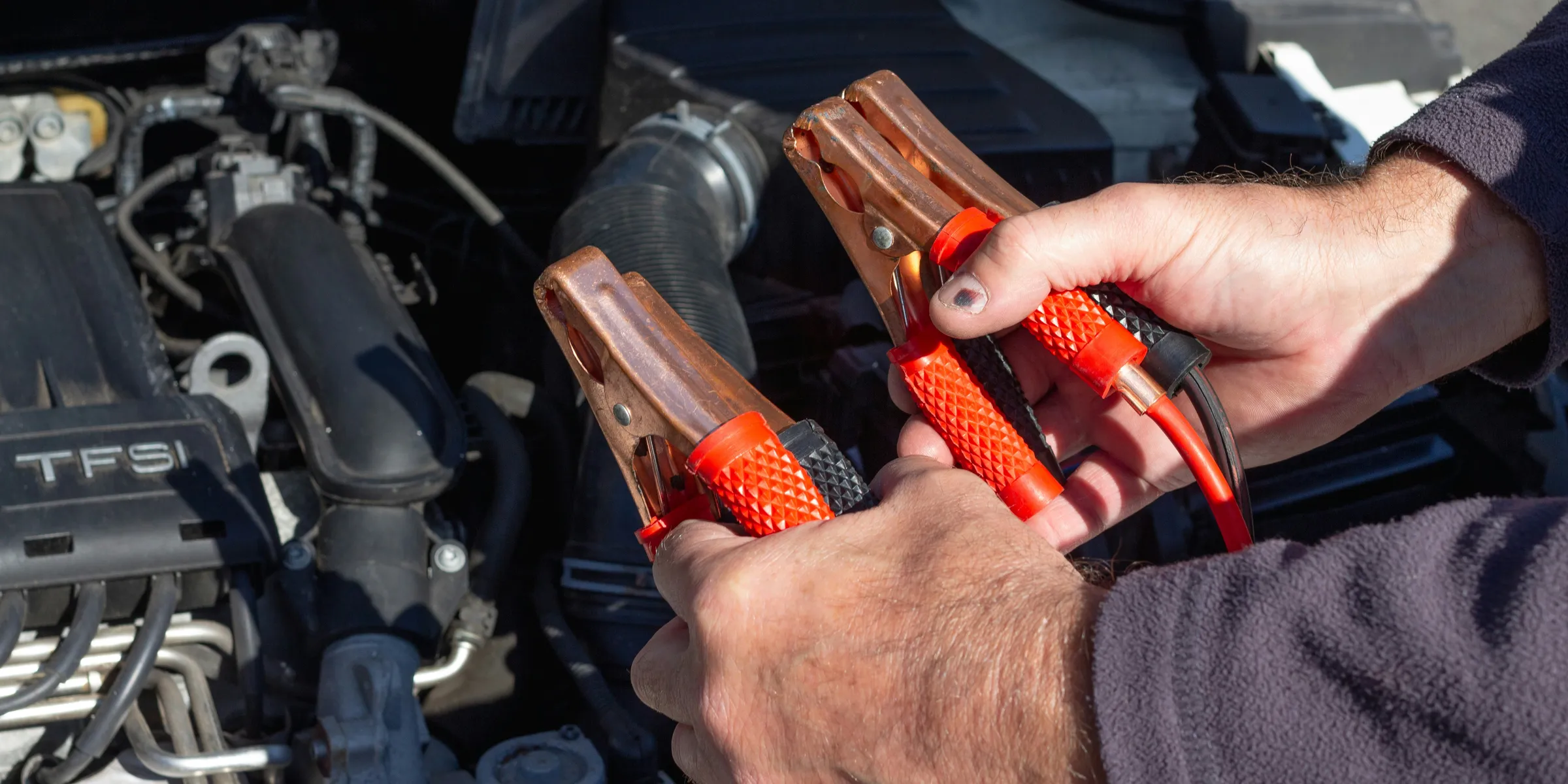 person holding red and black hand tool