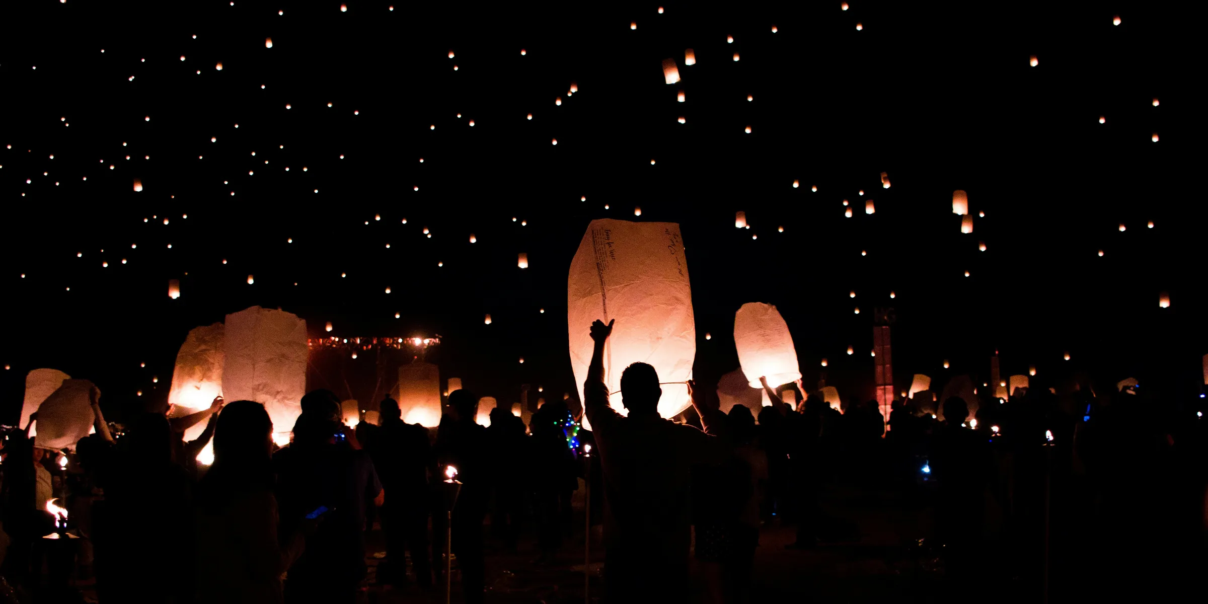 group of people holding lanterns
