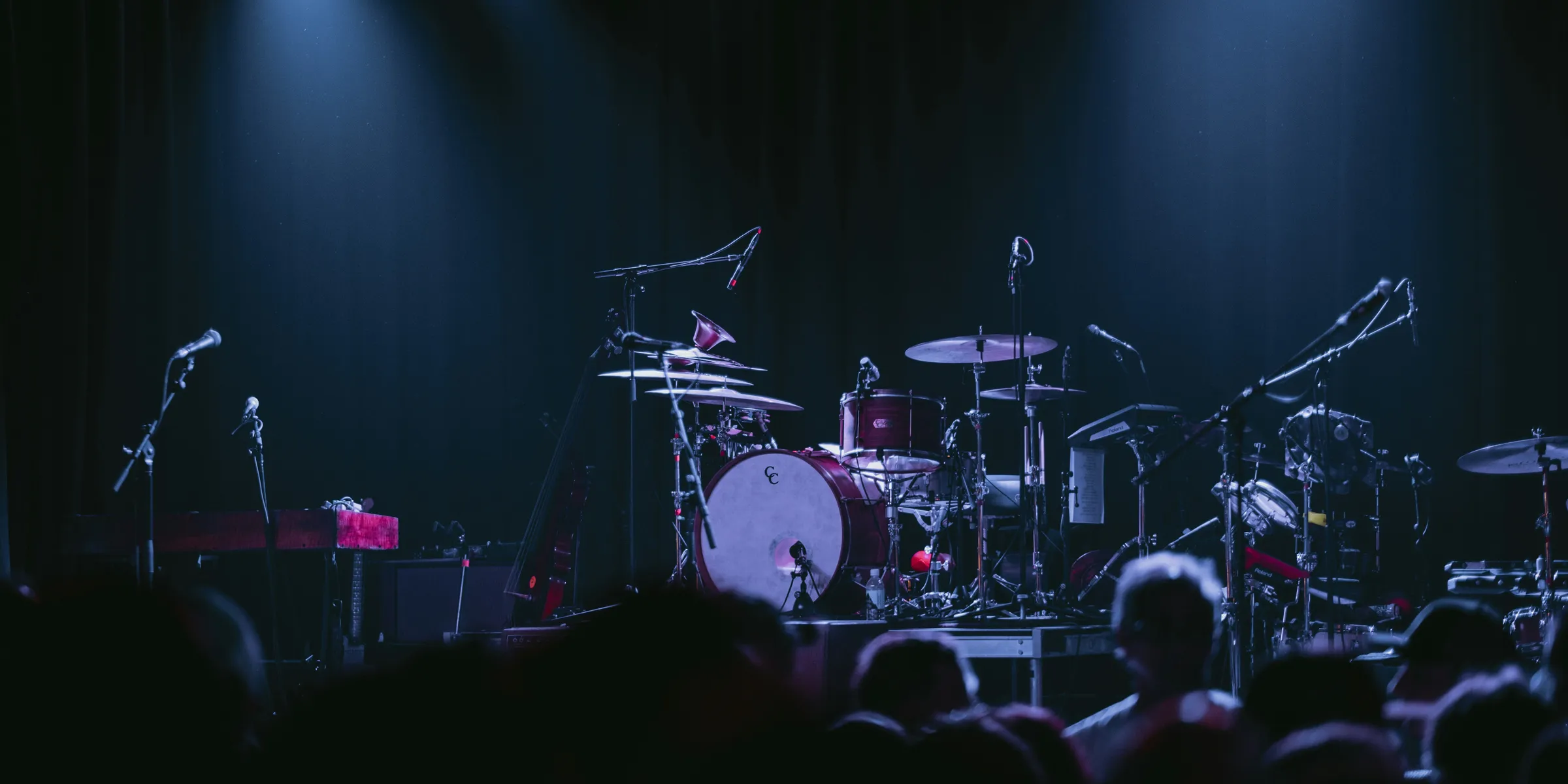 A band playing on stage in front of a crowd