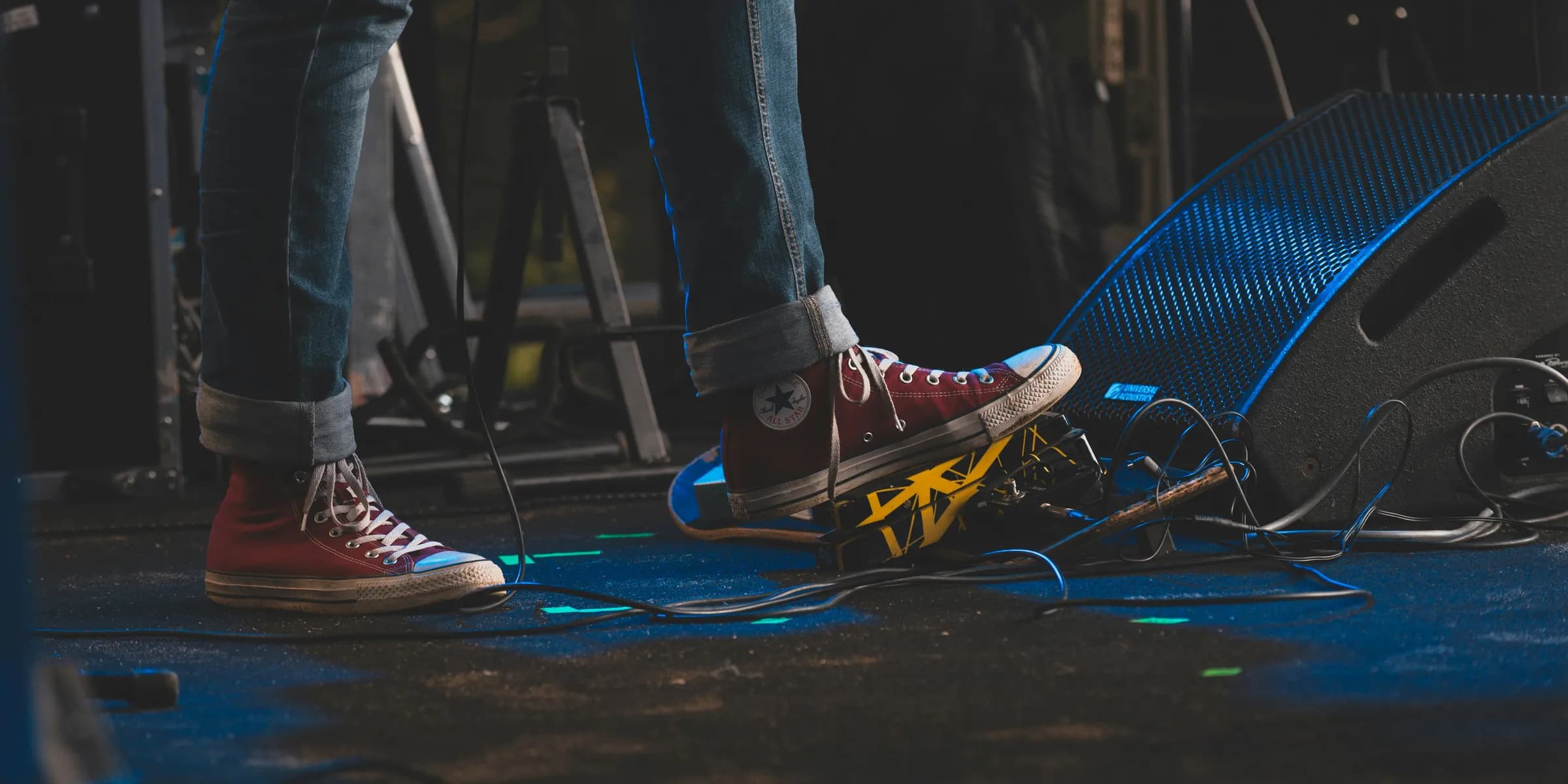 a person standing on top of a stage next to a microphone