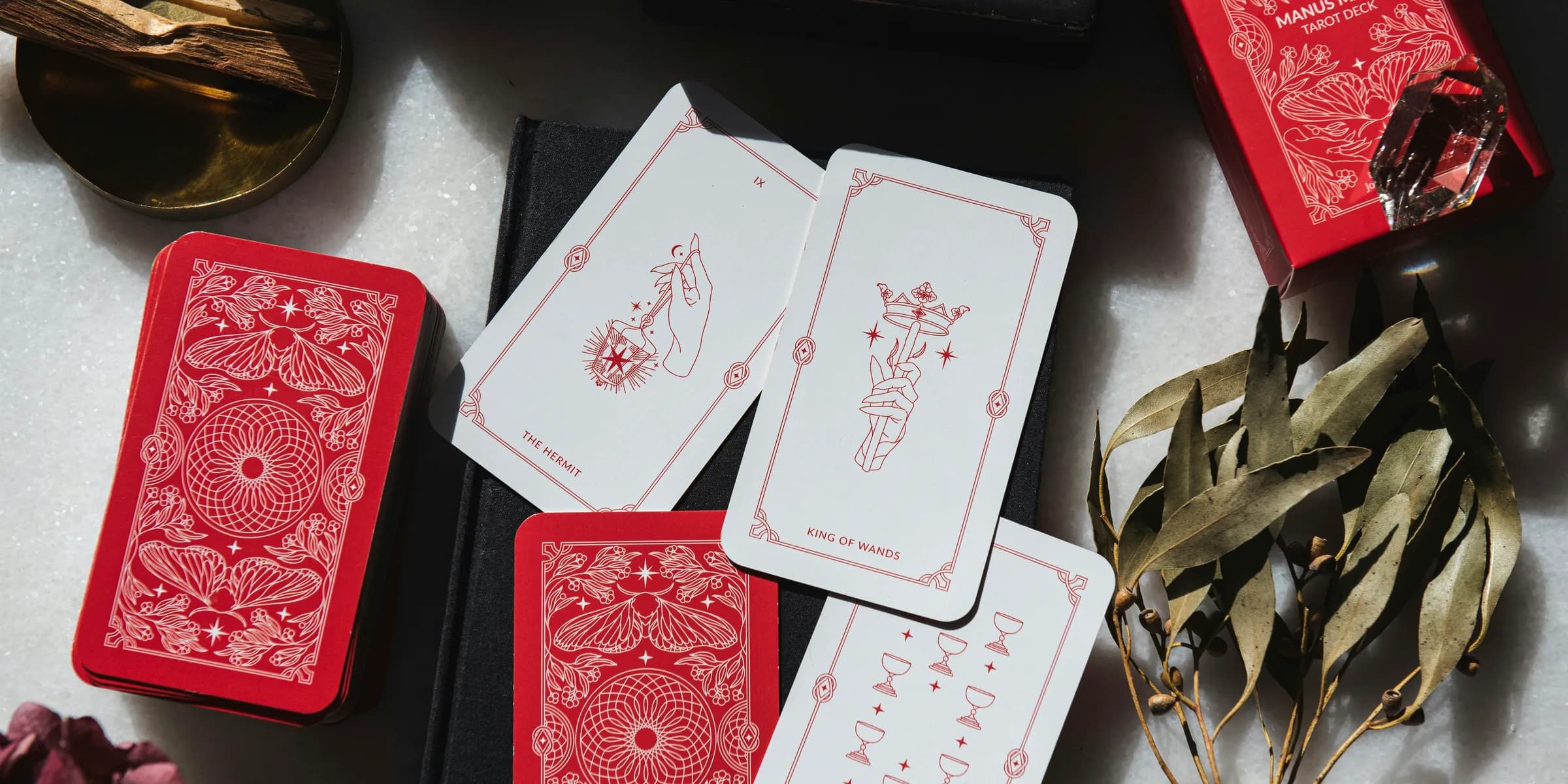 A table topped with lots of red and white playing cards