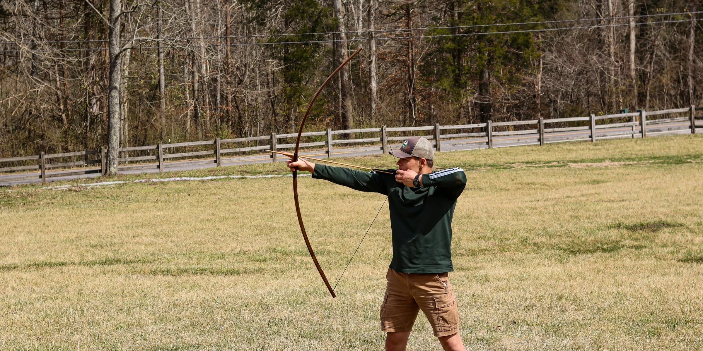 Person is shooting an arrow with a bow.