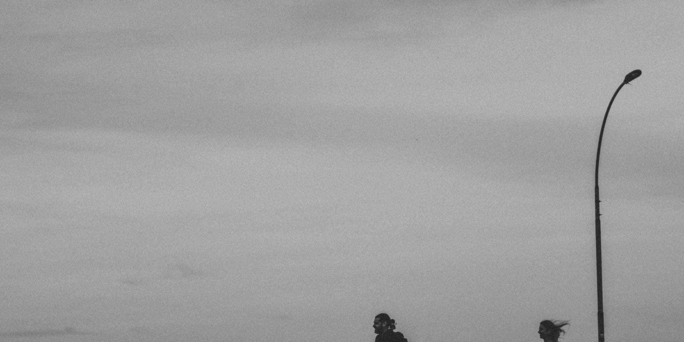 a couple of people standing on a bridge