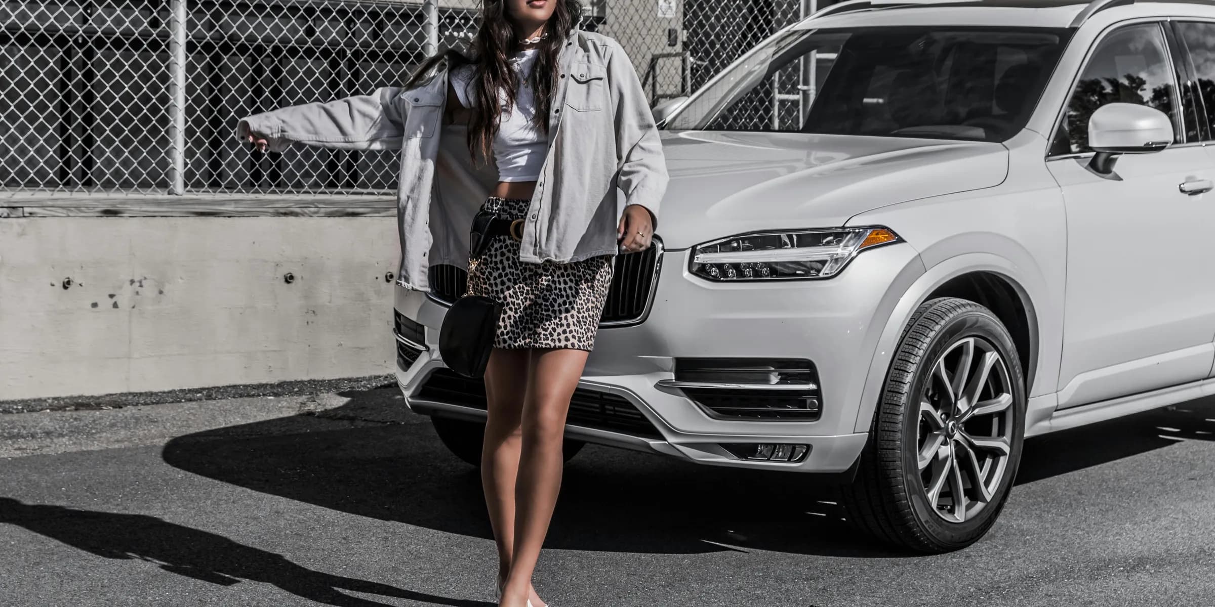 woman standing infront of whit SUV