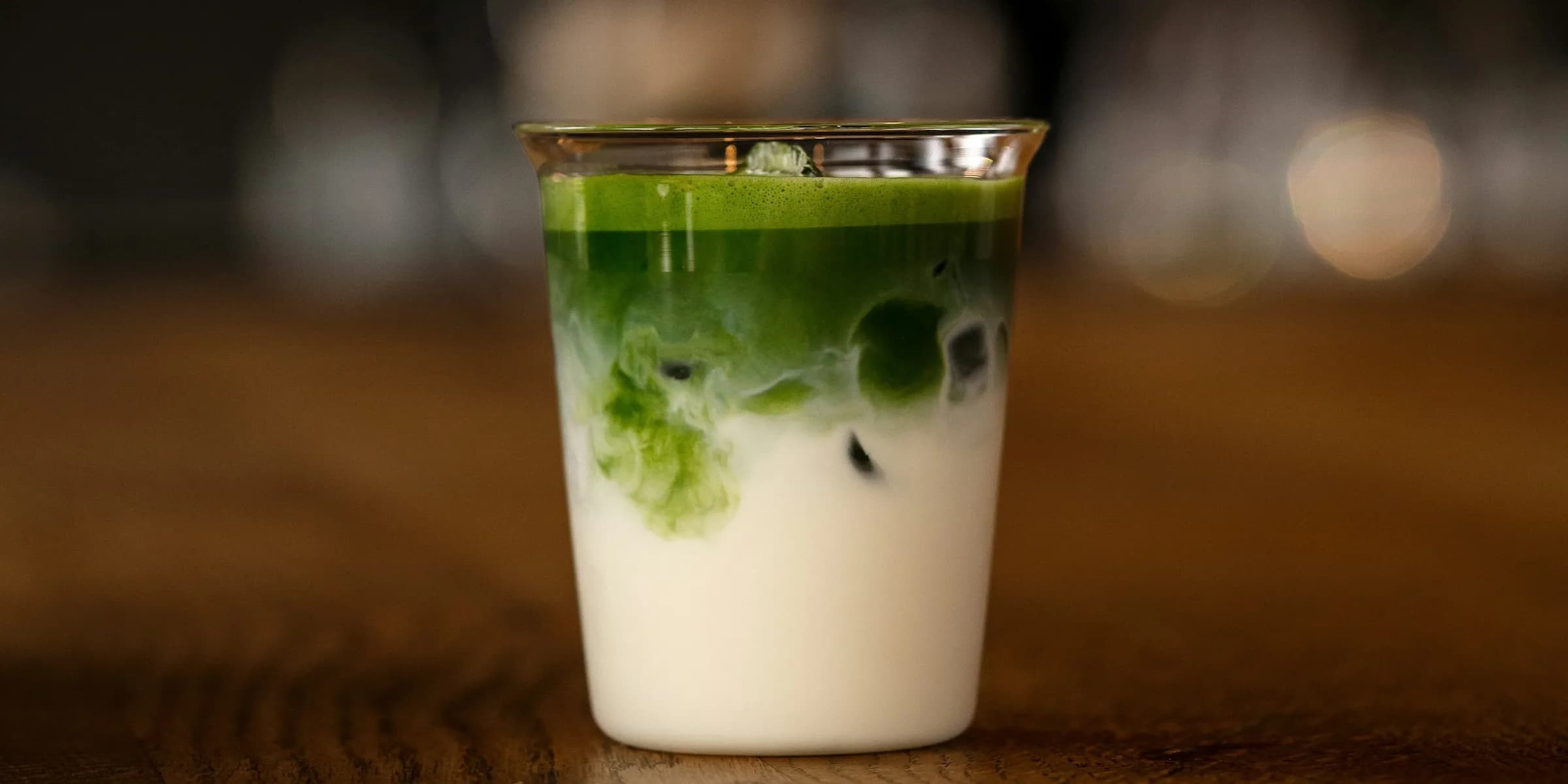 cup of matcha with milk on table