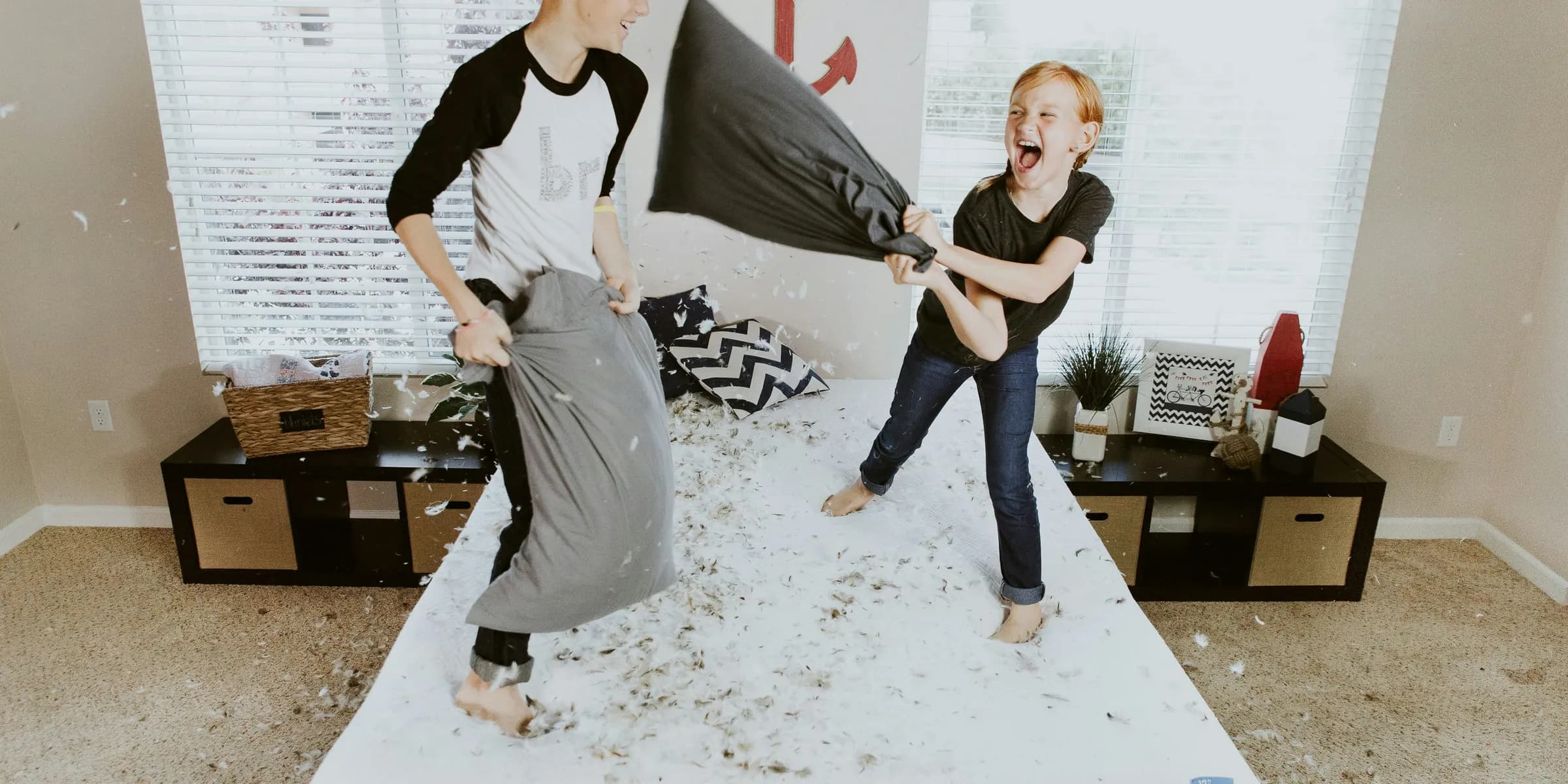 boy and girl having pillow fight