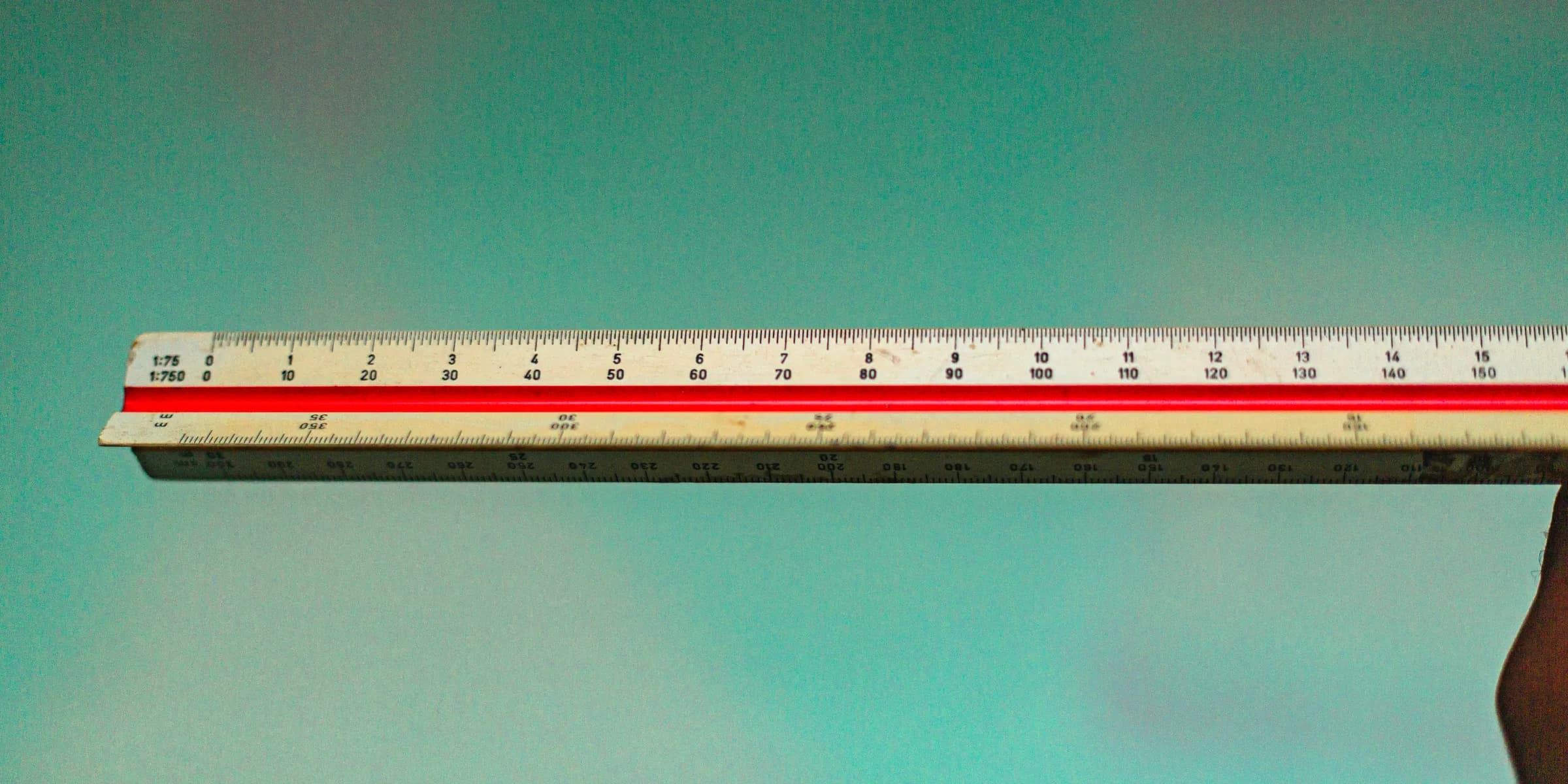 a person holding a ruler in their hand