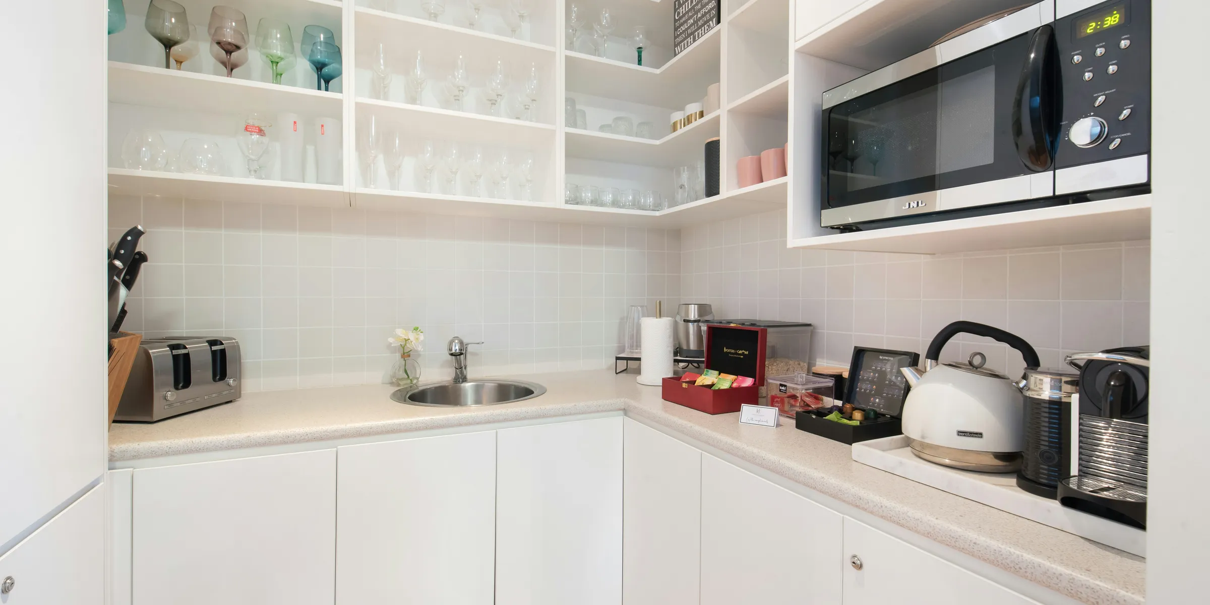 a kitchen with white cabinets and a microwave