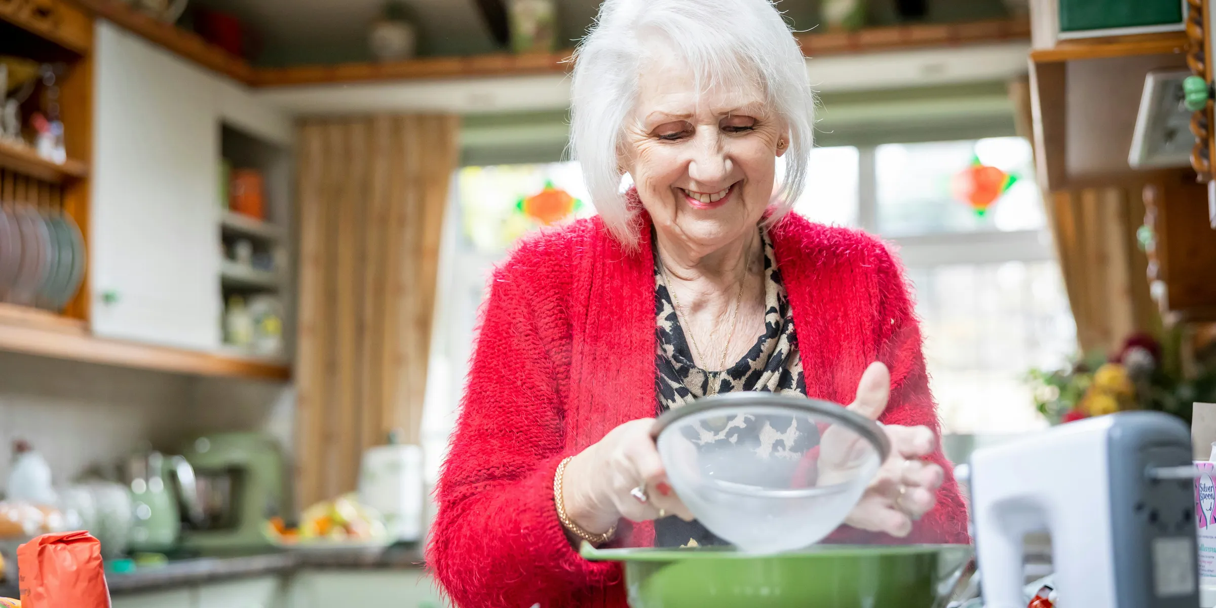 a woman mixing a bowl in a kitchen