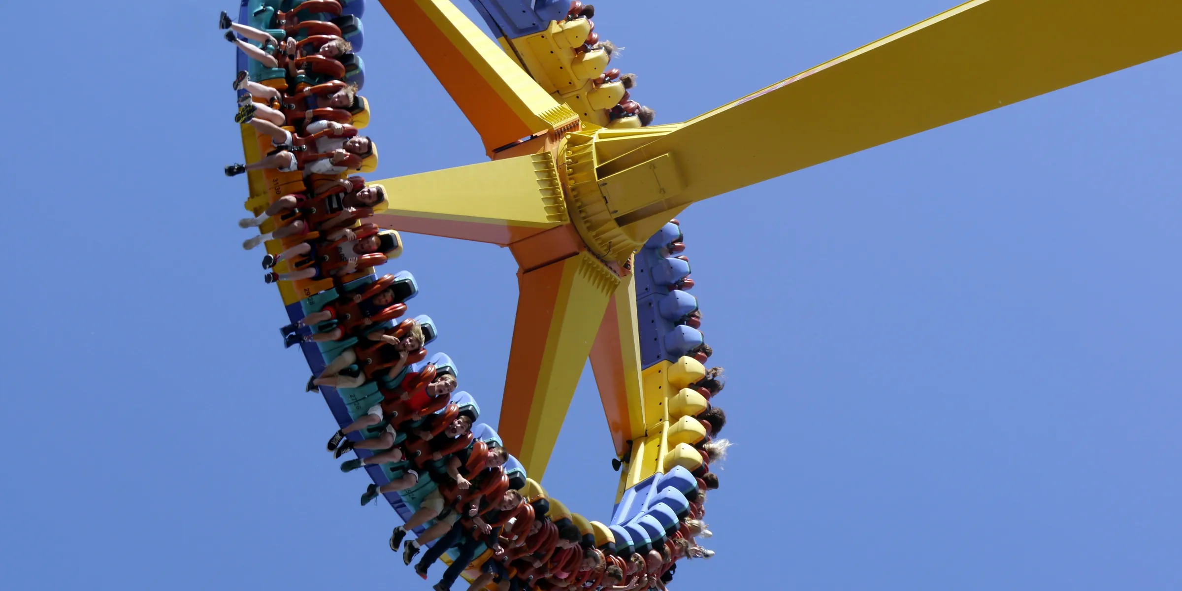 low-angle photography of people on yellow playground equipment