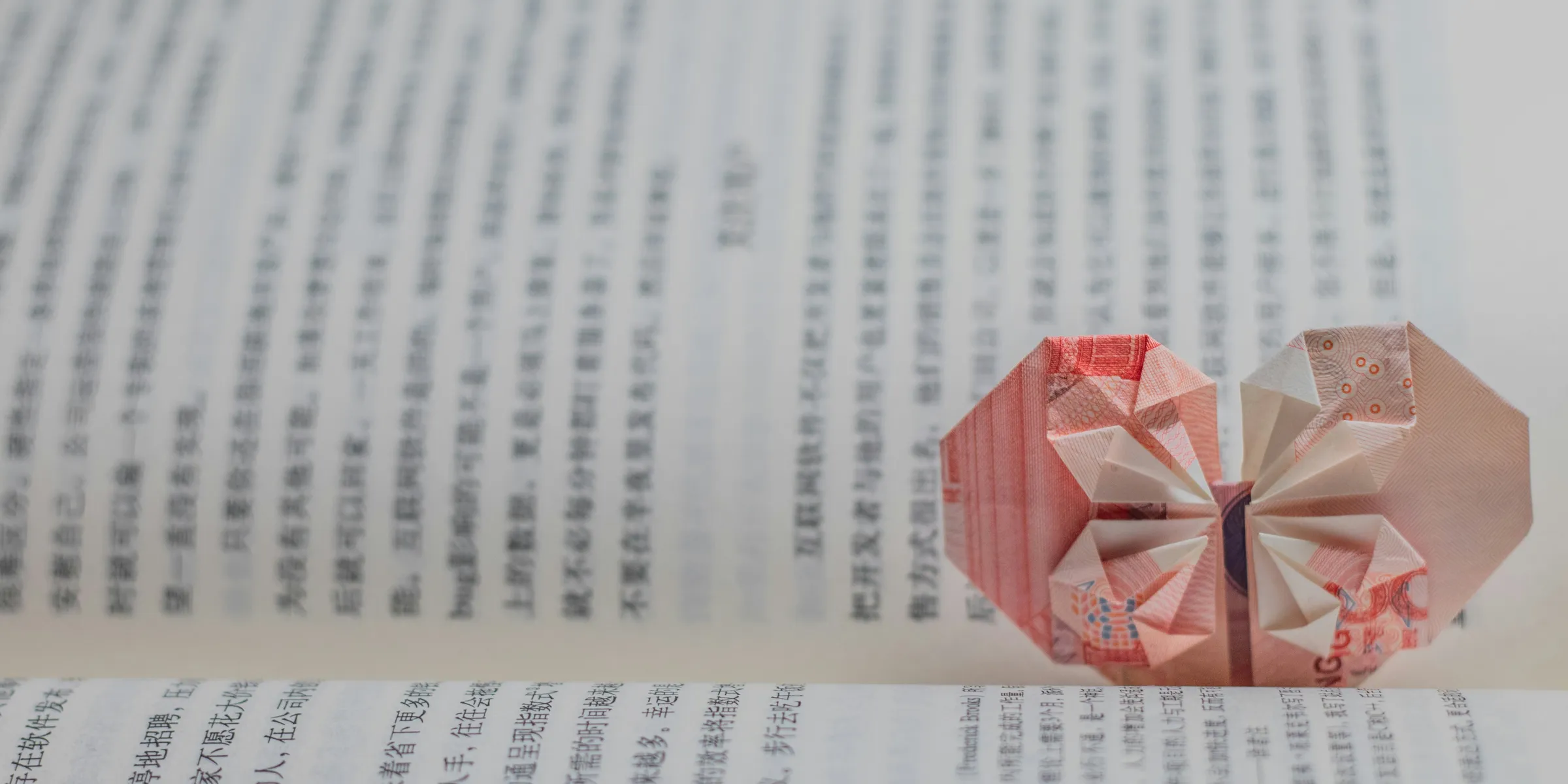 red and white paper boat on white printer paper