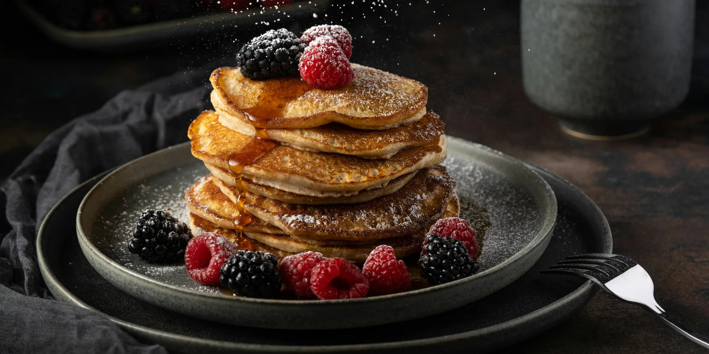 a stack of pancakes with berries on top