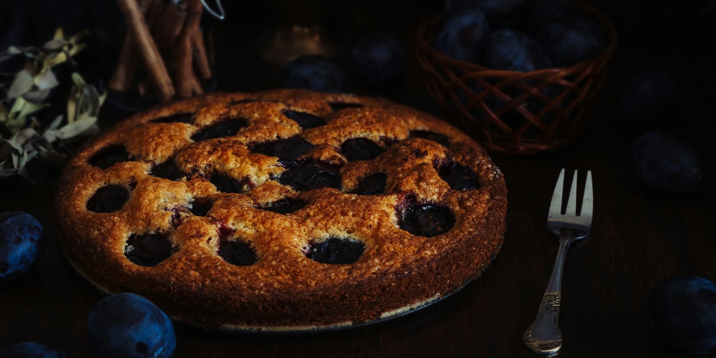 a blueberry pie on a table with a fork