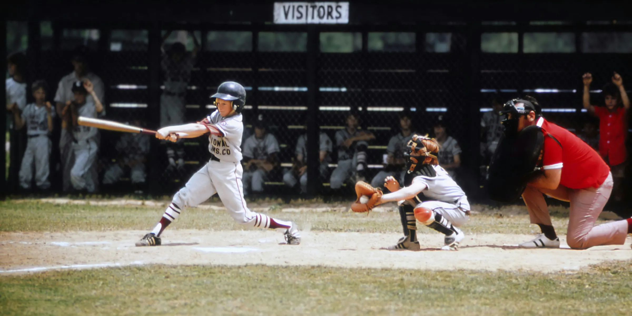 a baseball player swinging a bat at a ball