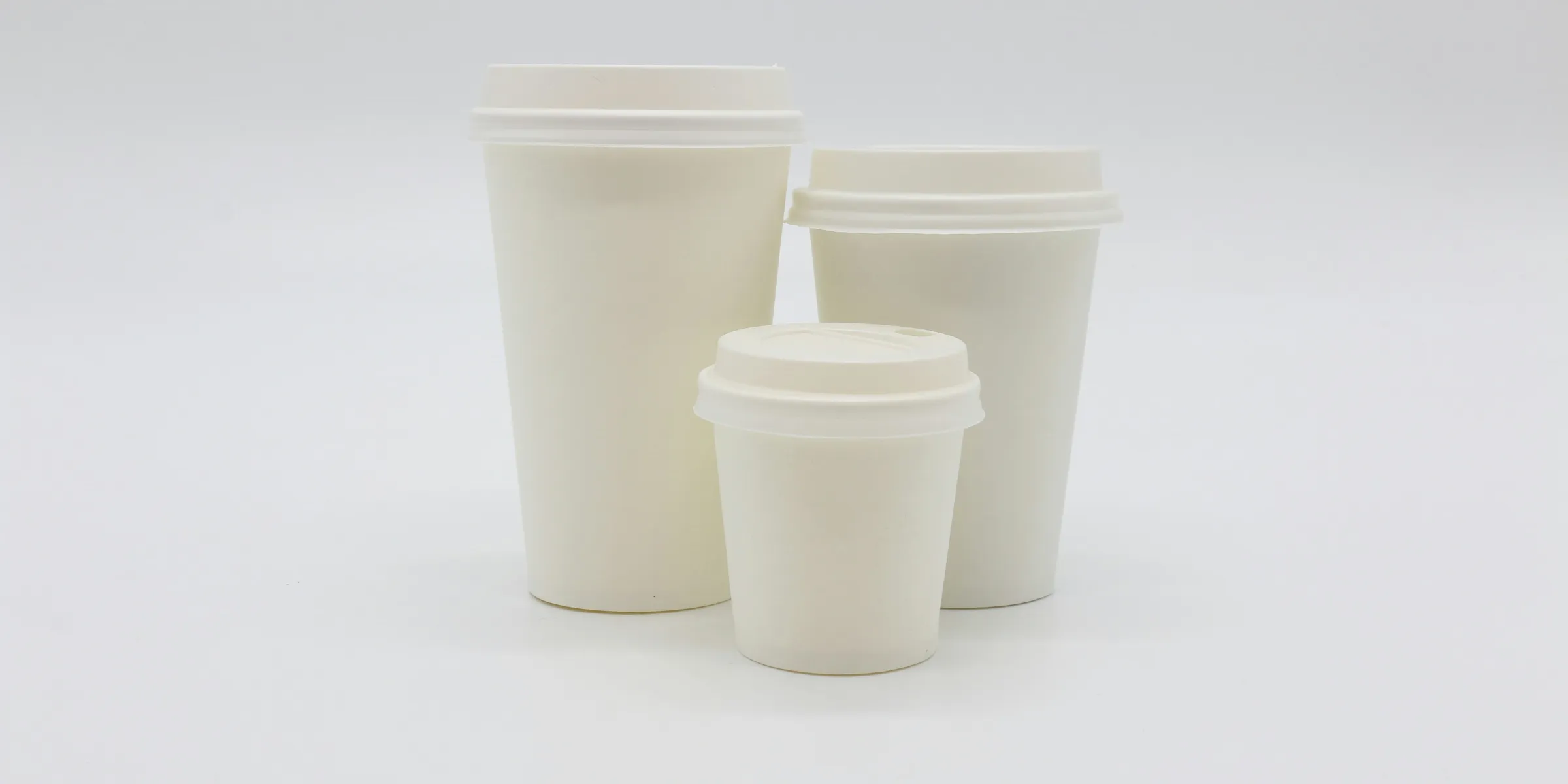 three white disposable cups